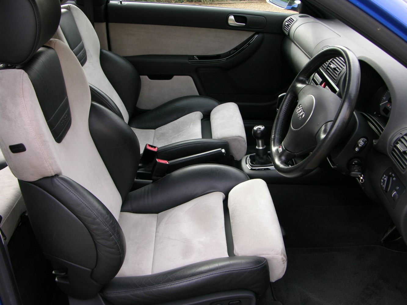 Sport seats and manual gearstick in car interior