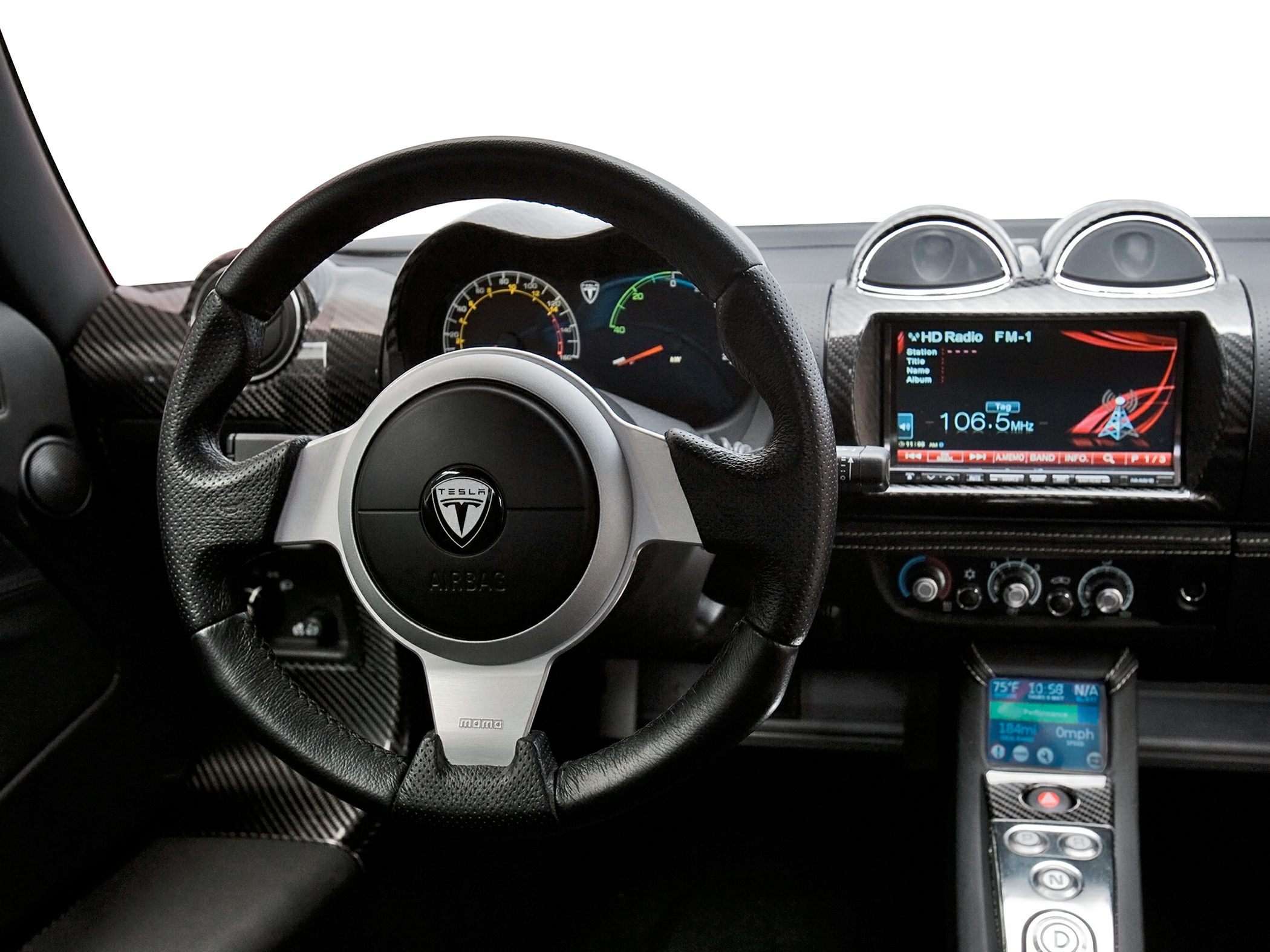 Steering wheel, dashboard with gauges, carbon fiber trim, infotainment screen