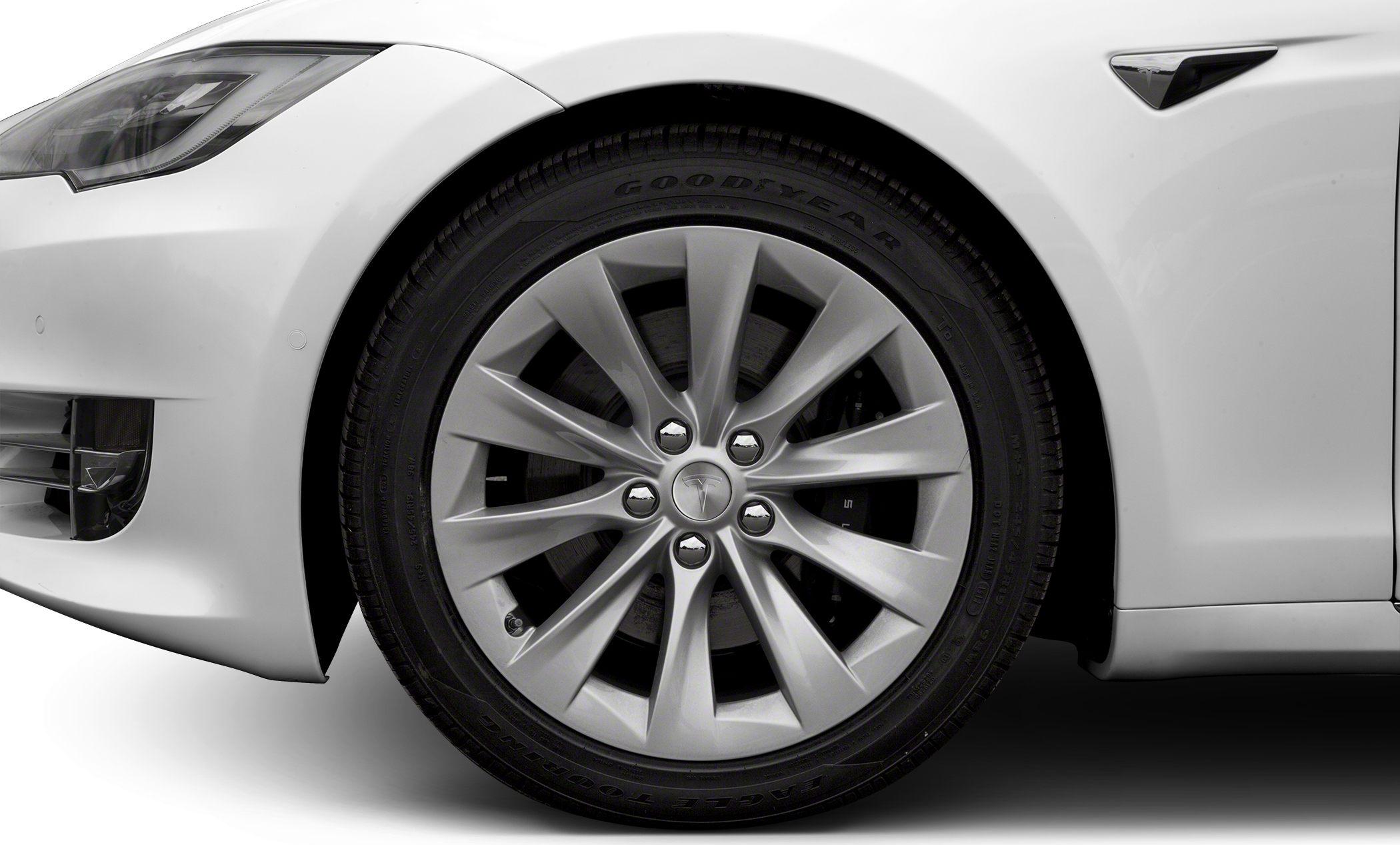 Close-up of alloy wheel and front fender with Tesla logo