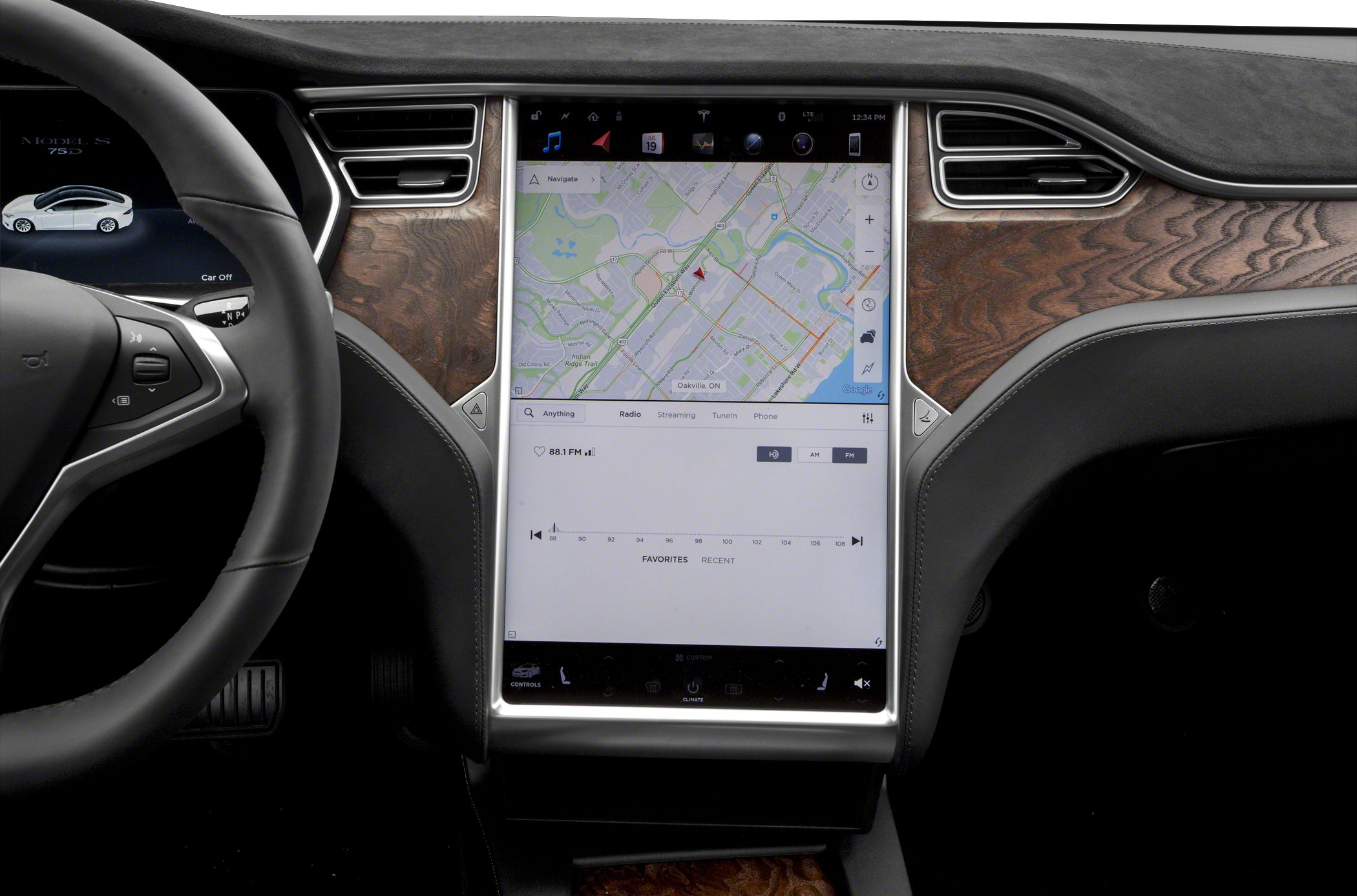 Large central touchscreen with wood trim dashboard.