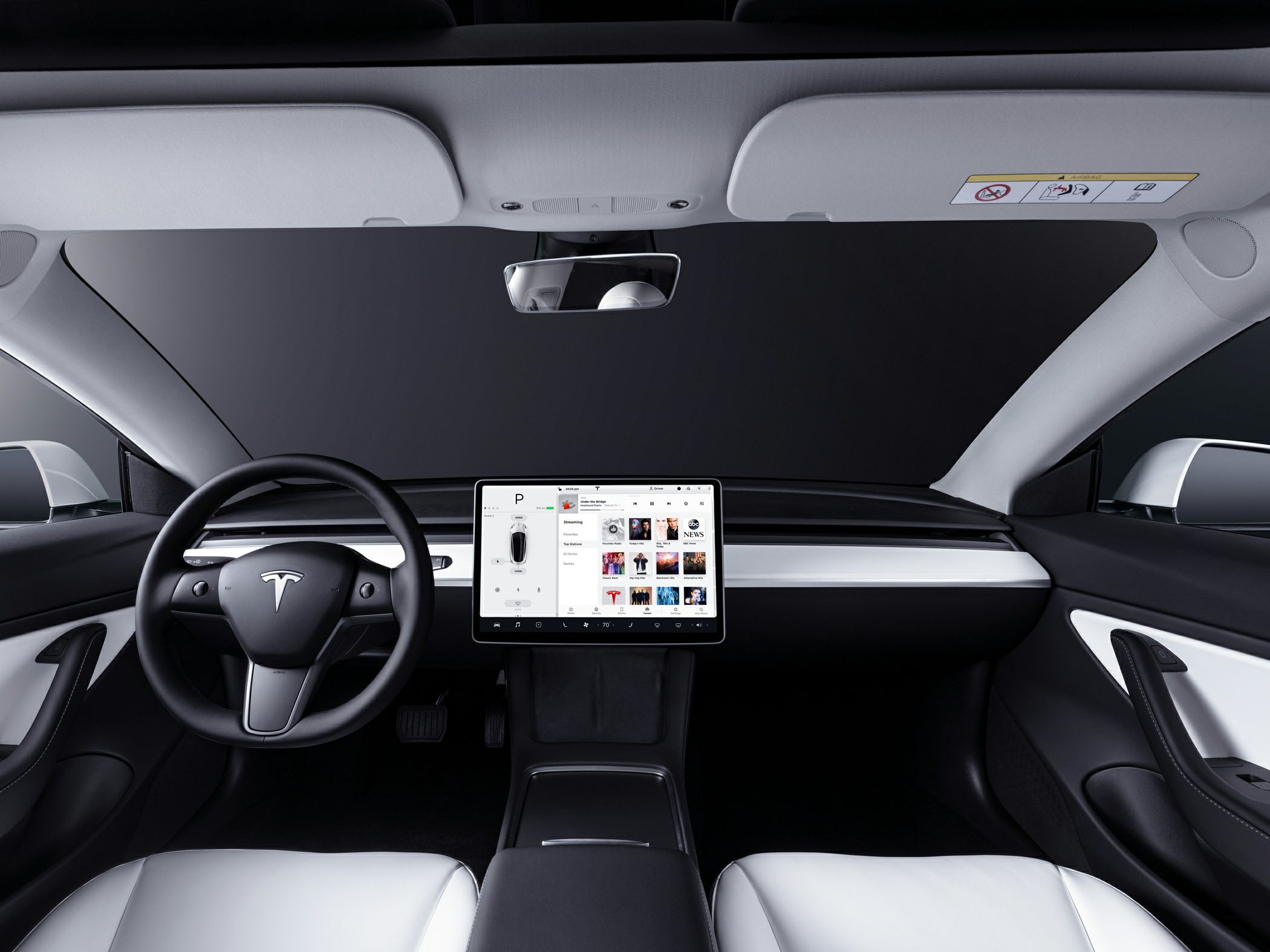 Minimalist dashboard with central touchscreen and steering wheel