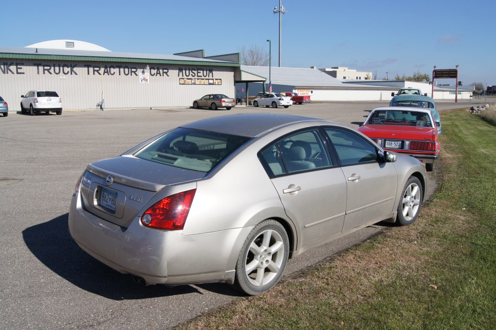 Rear and side view of a sedan with distinctive taillights and alloy wheels.