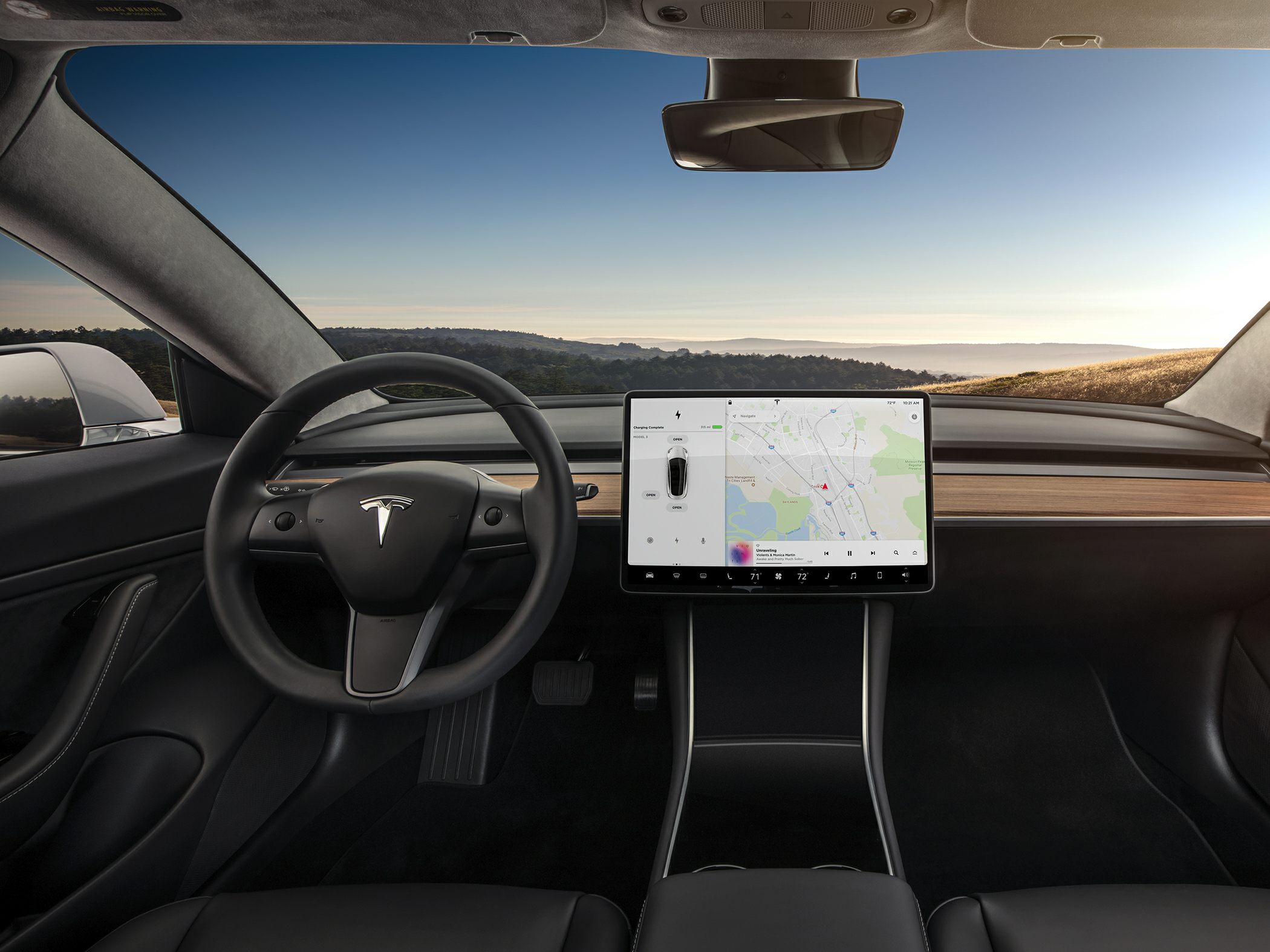 Minimalist black interior with central touchscreen and wood trim
