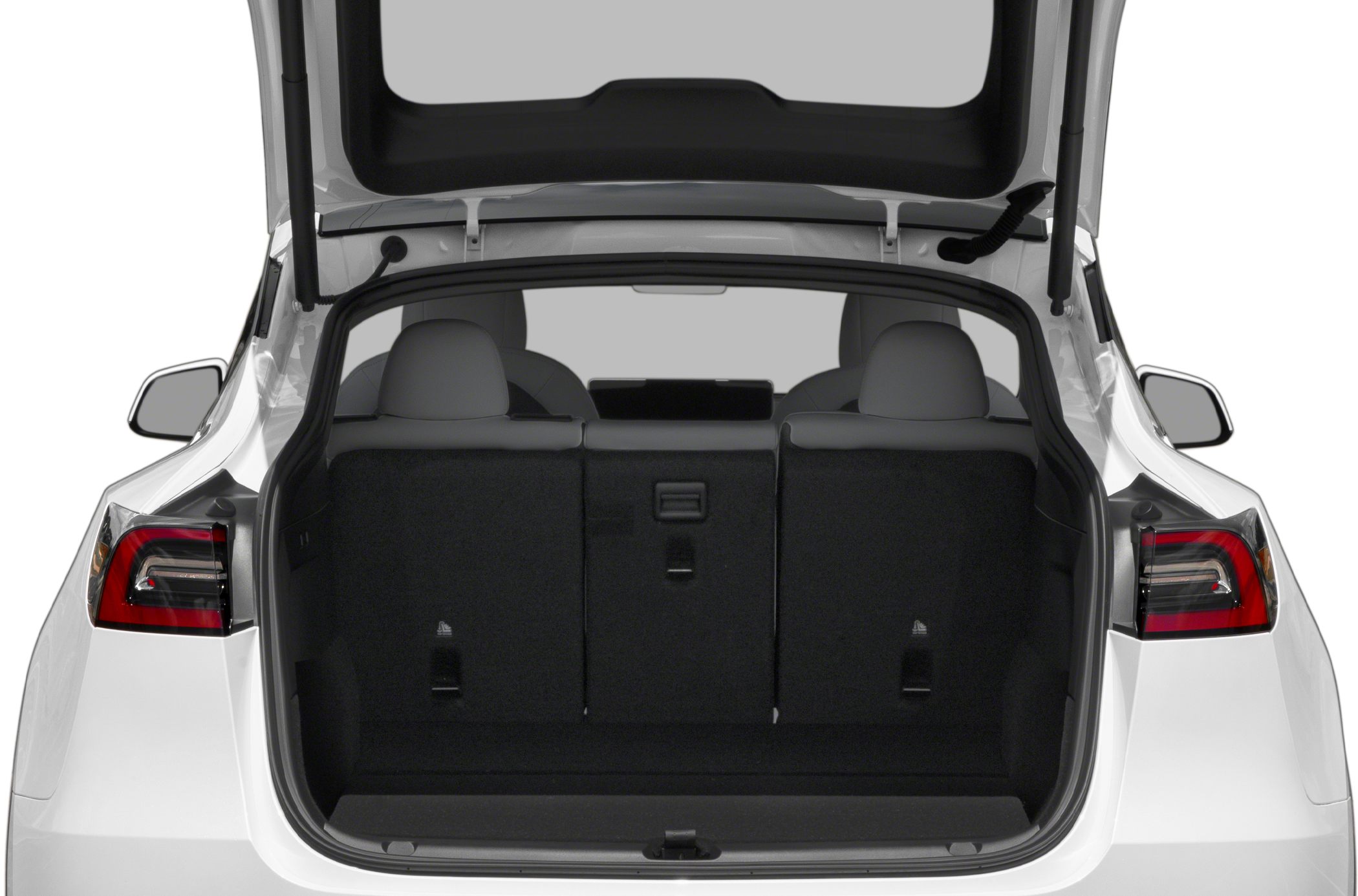 Open rear trunk of an electric hatchback with foldable rear seats.