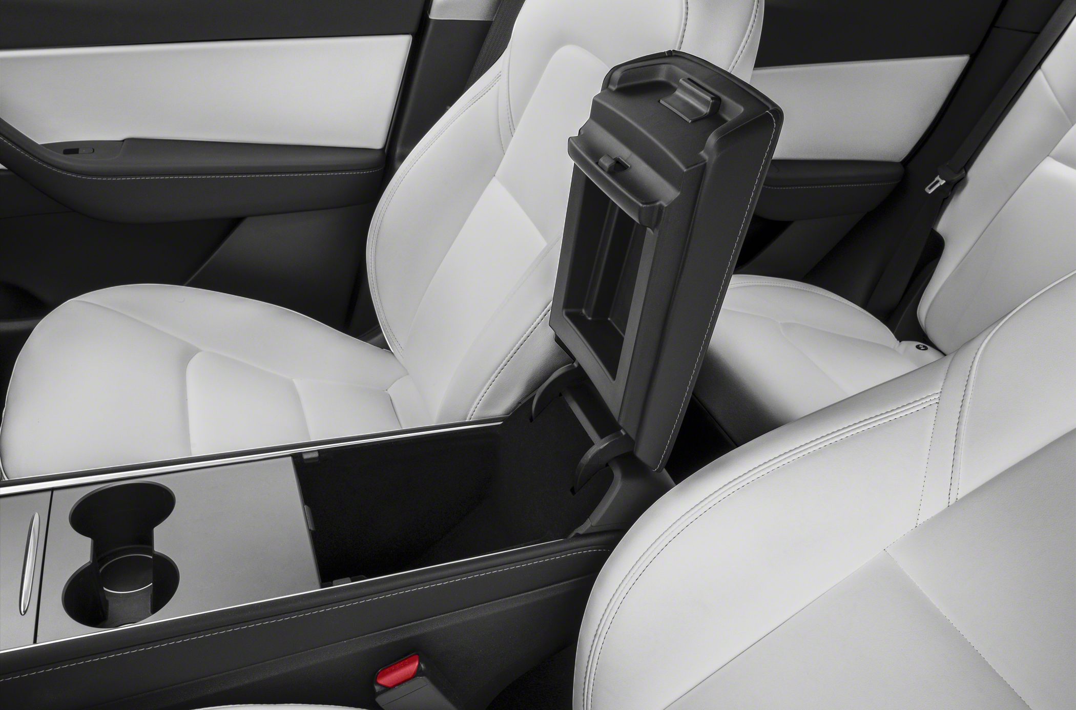 Open center console storage and white leather seats inside a car