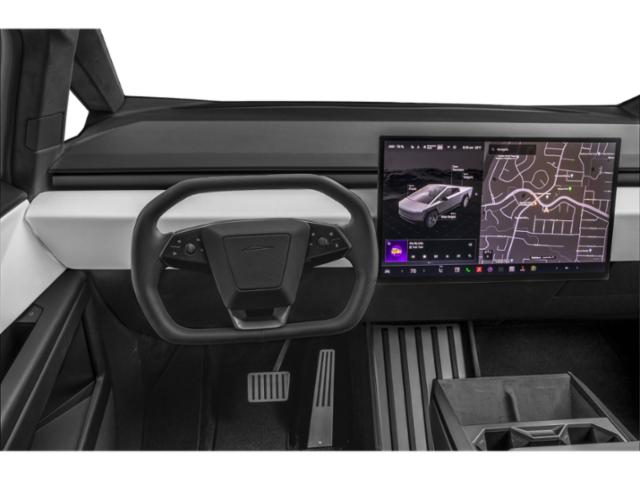 Yoke steering wheel and dual digital touchscreen dashboard.