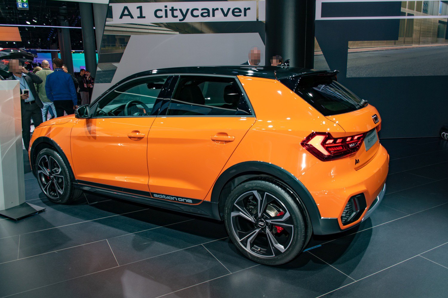 Orange compact crossover with black roof and LED taillights