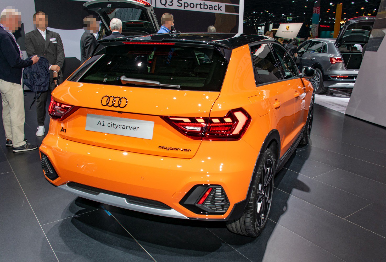Rear view of orange hatchback with LED tail lights and sporty design