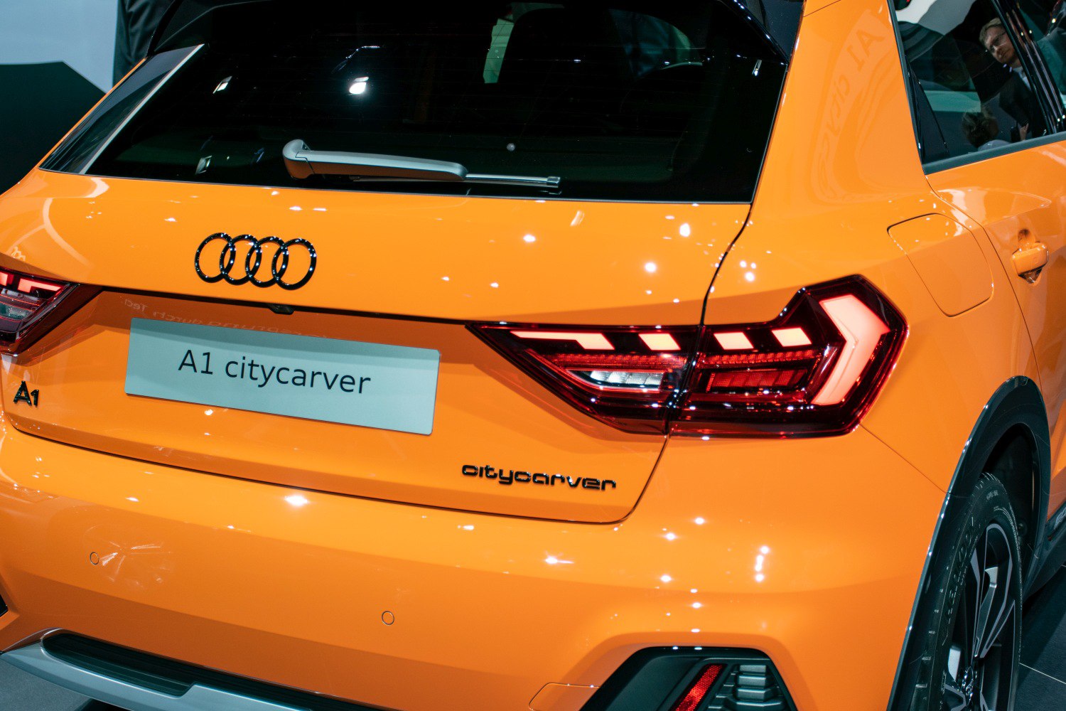 Rear LED taillights and hatchback design of an orange compact vehicle