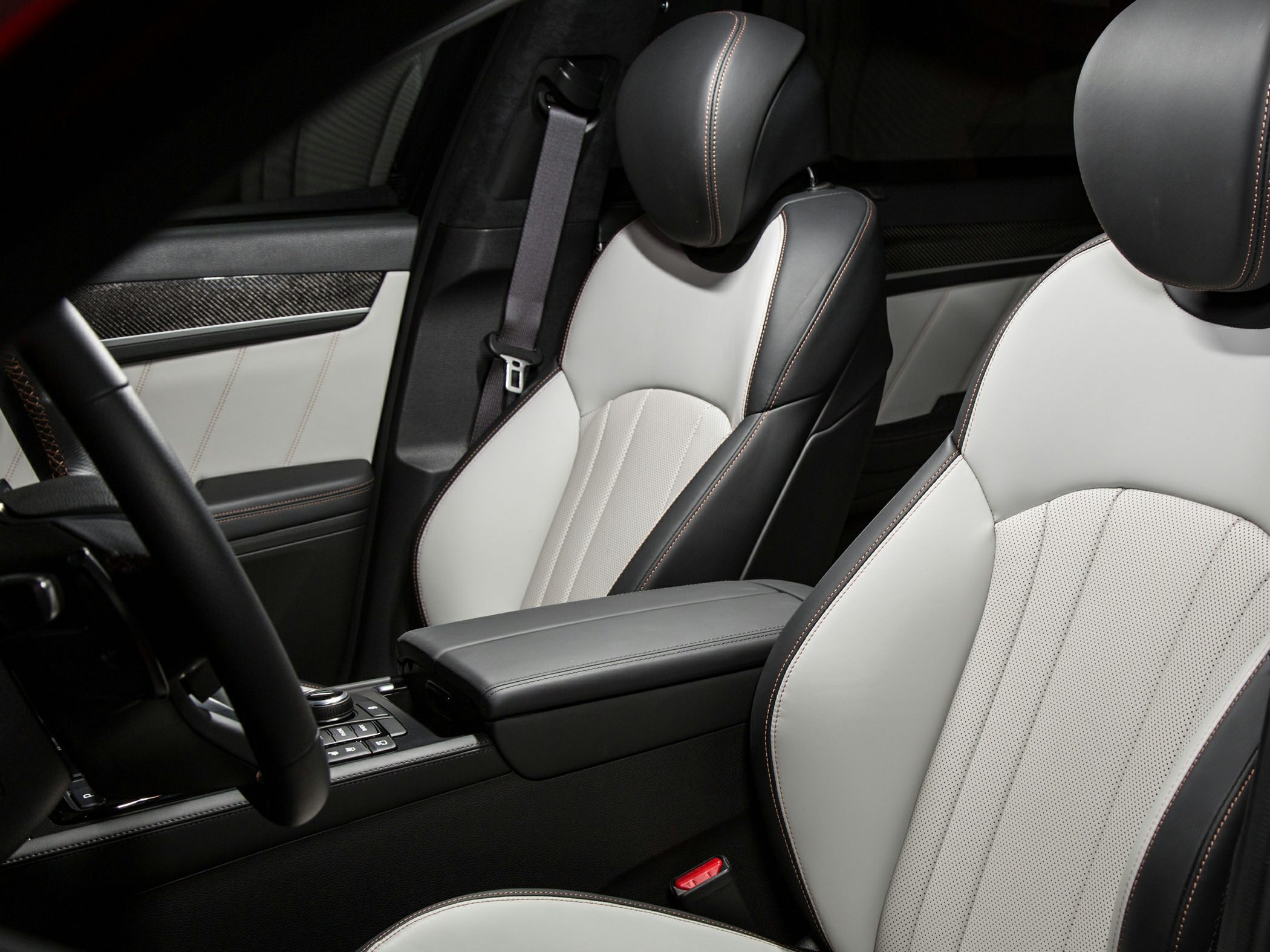 Luxury two-tone leather seats with detailed stitching and armrest