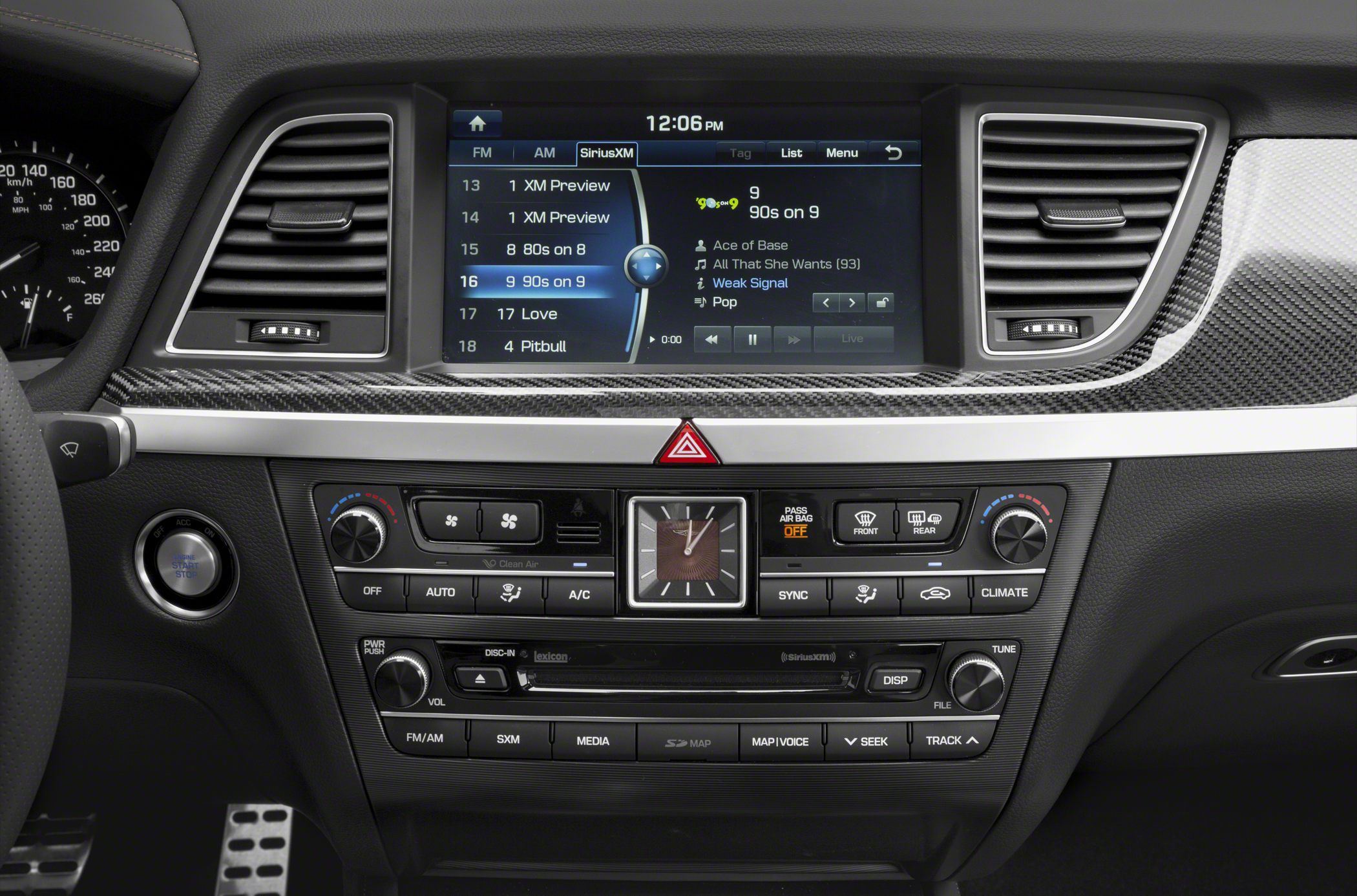 Multimedia screen, climate controls, analog clock in car interior