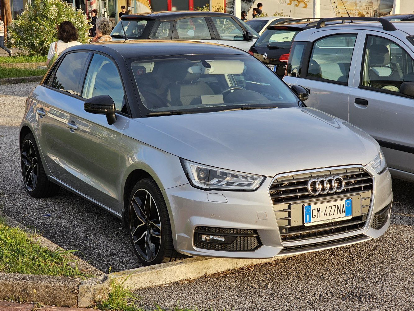 Silver compact hatchback with black roof and LED headlights