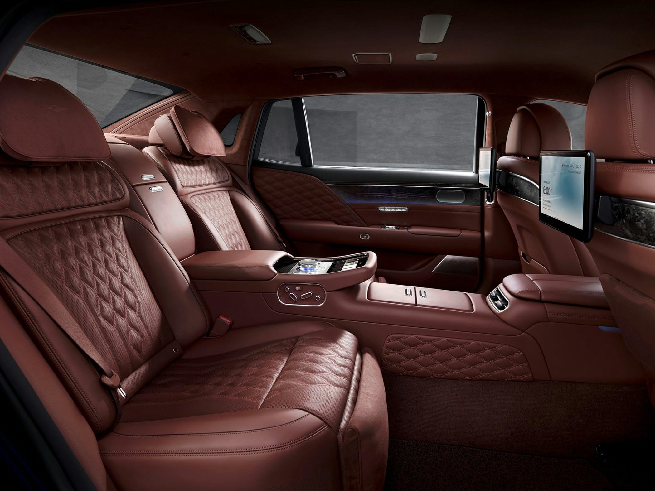 Quilted leather rear seats with dual rear entertainment screens in luxury car interior