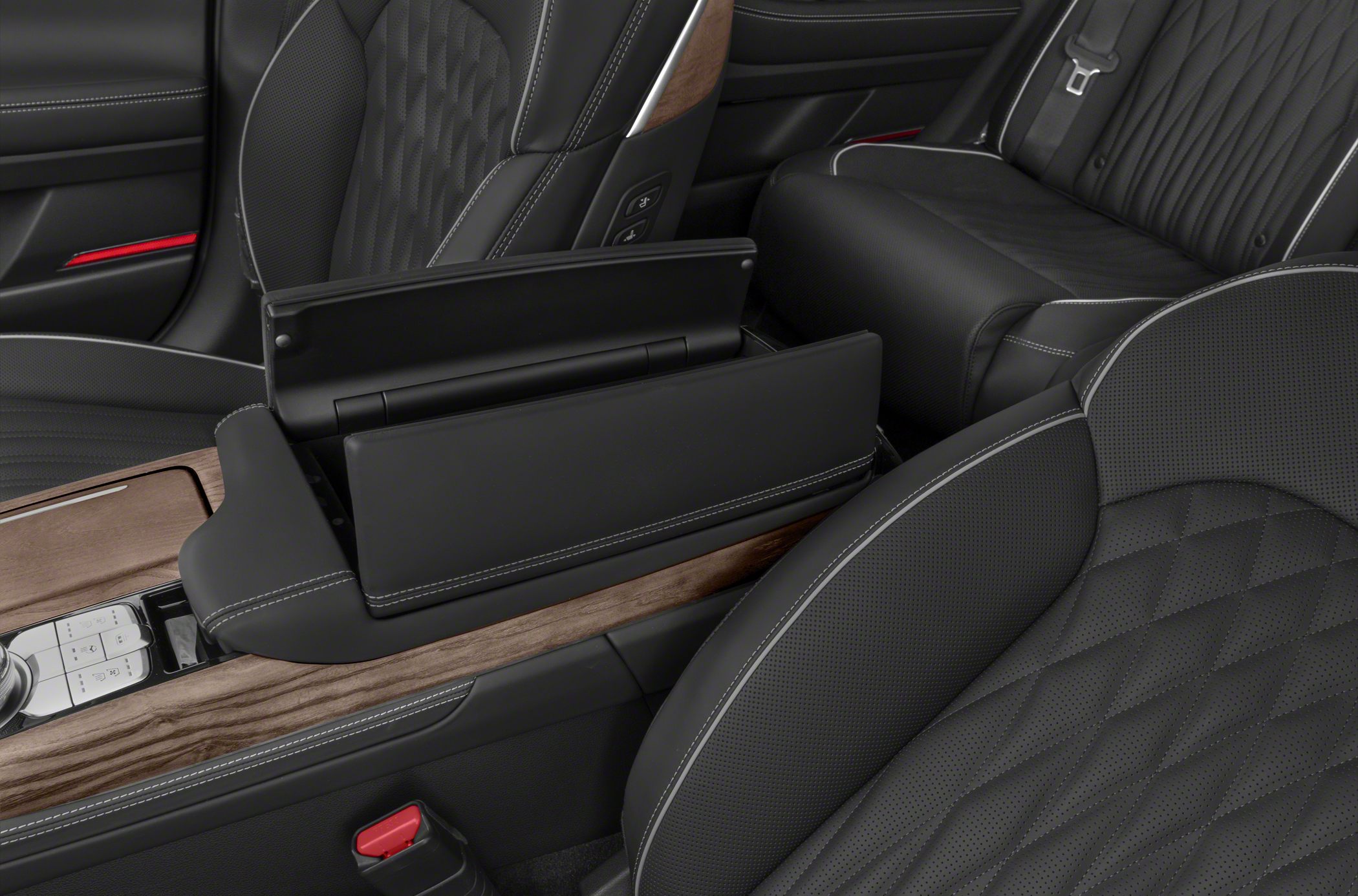 Quilted black leather seats with white stitching and wood trim center console.