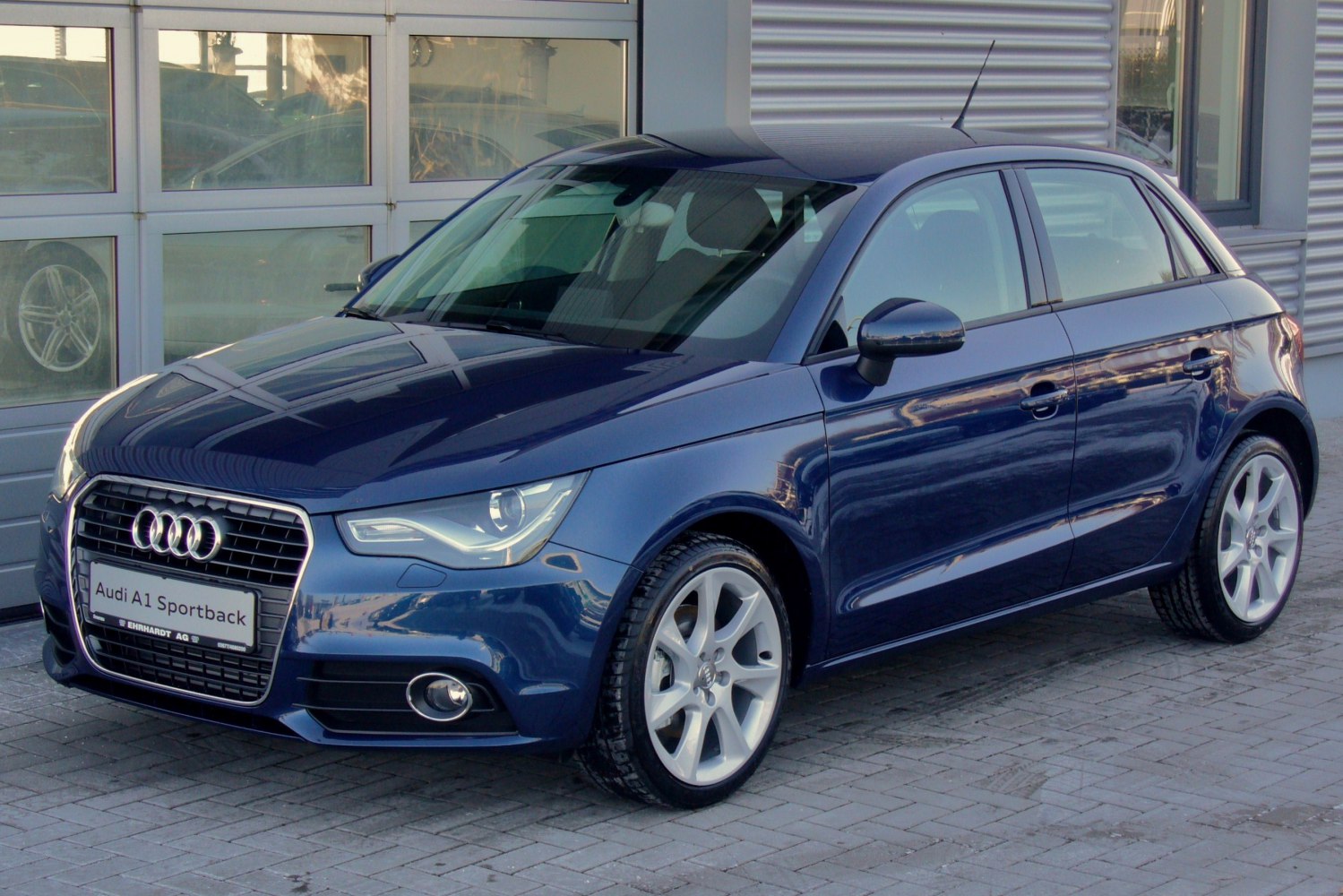 Compact hatchback with sleek headlights and alloy wheels