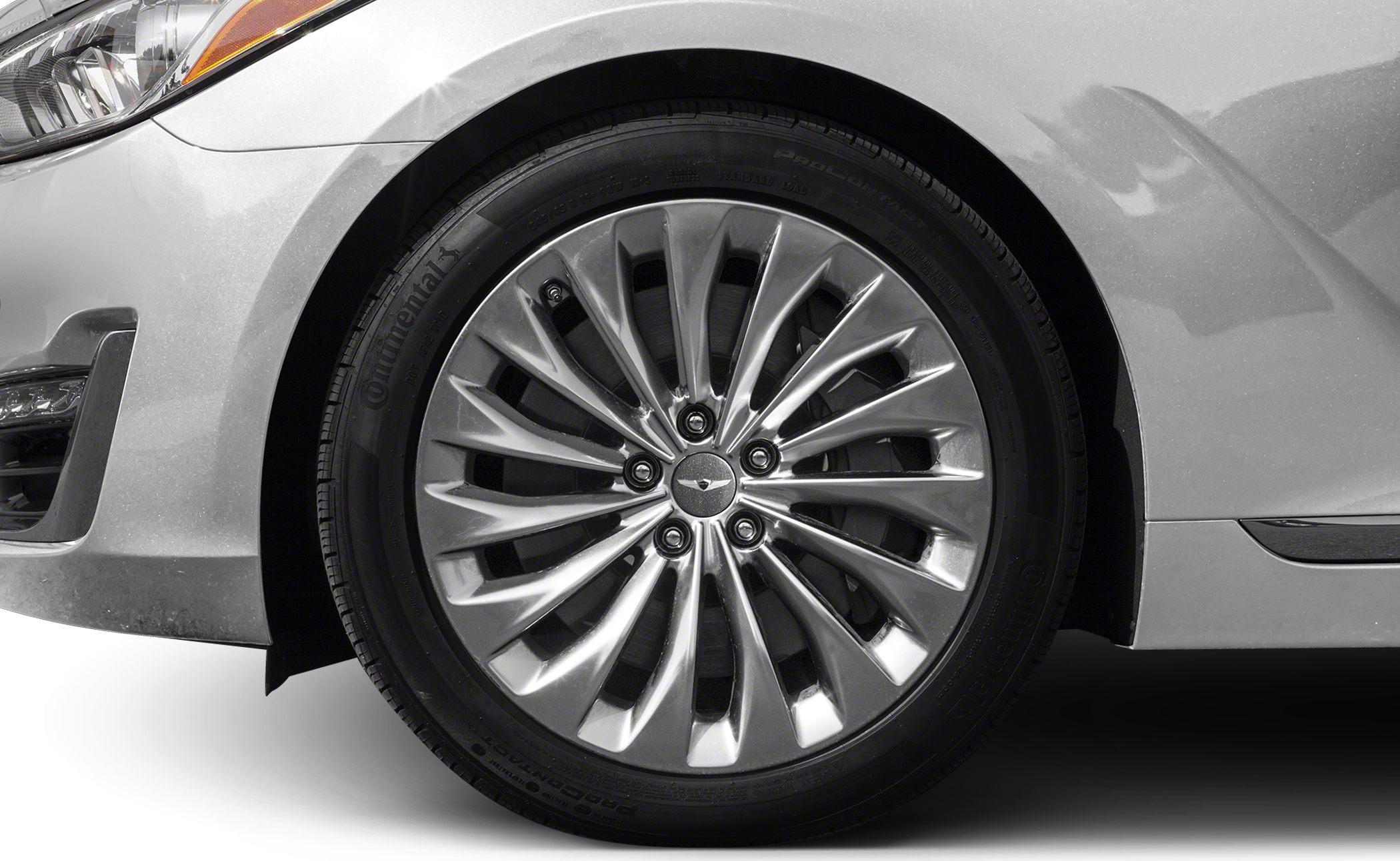 Multi-spoke alloy wheel with Continental tire on silver car section