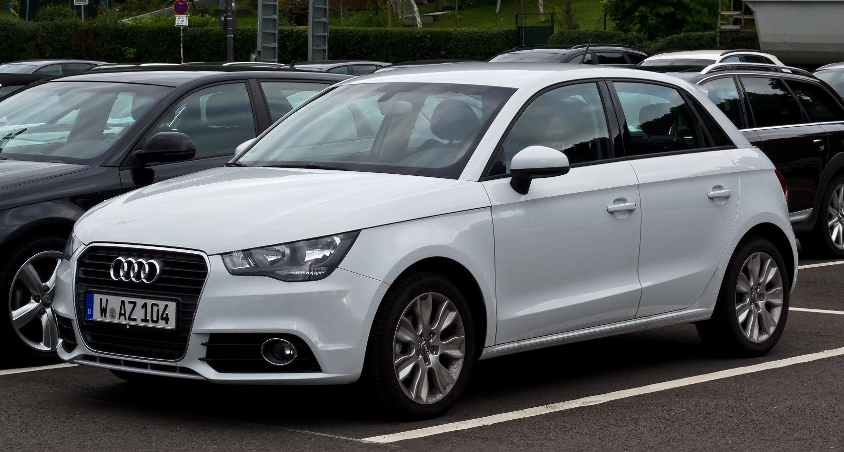 White compact hatchback showing front side profile and grille