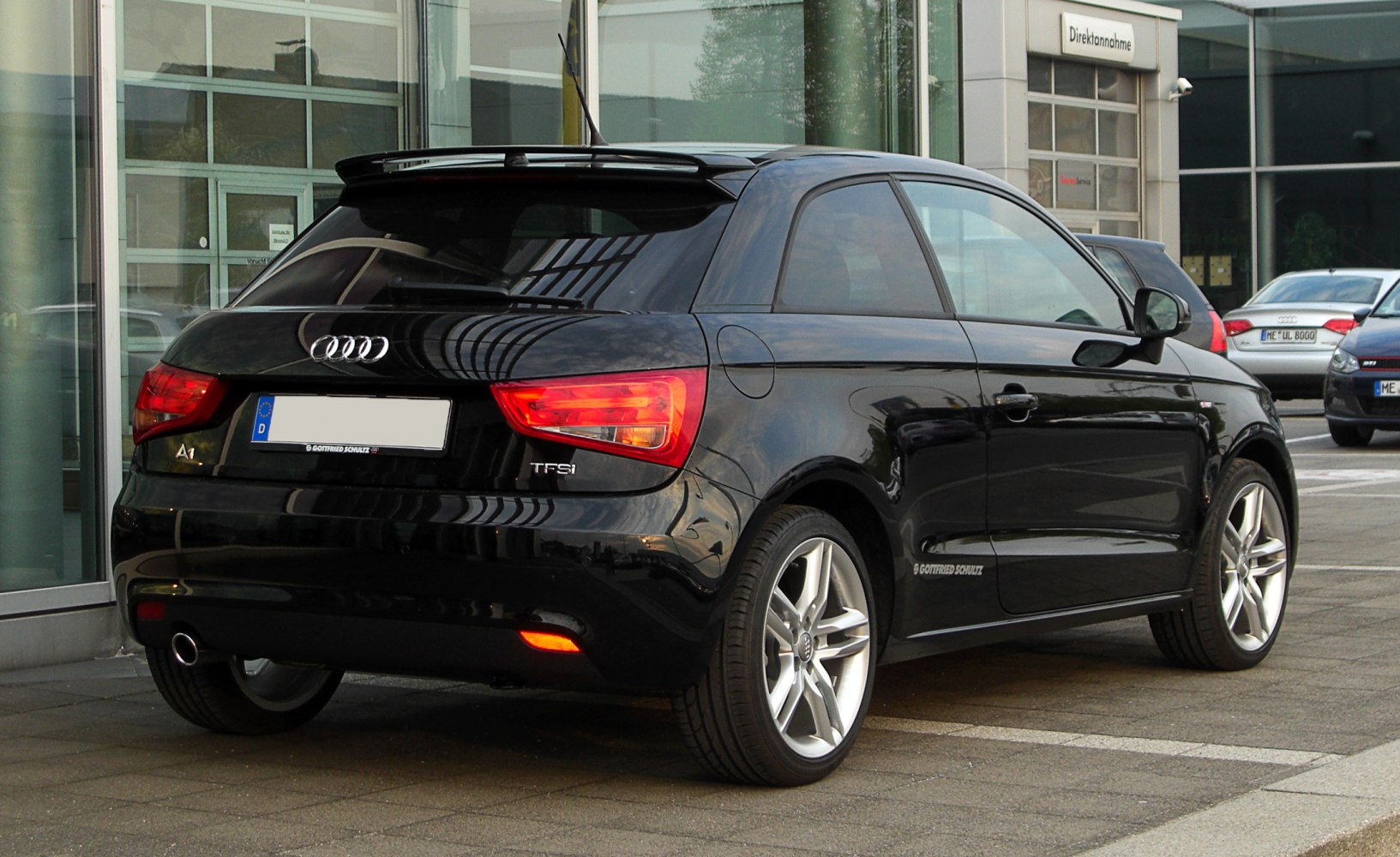 Black hatchback rear view with taillights and spoiler
