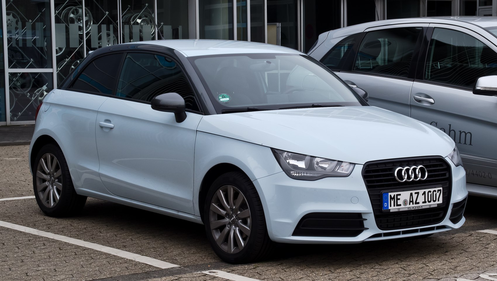 Front and side view of compact hatchback with LED headlights and black grille