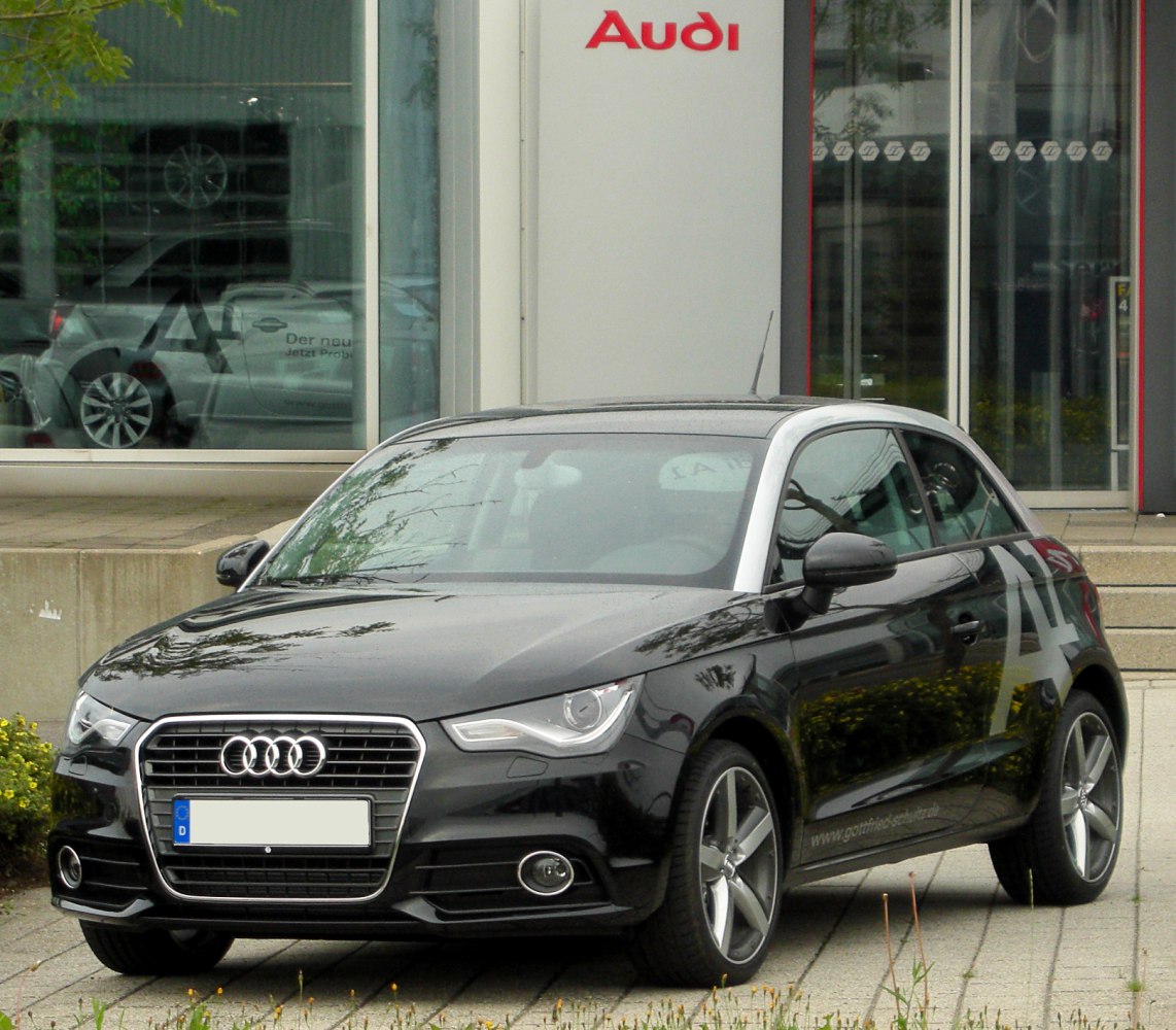 Front three-quarter view with silver roof frame and black body