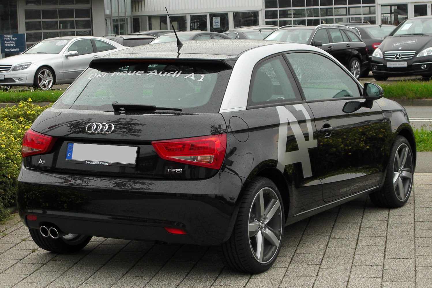 Rear view of hatchback with TFSI badge and dual exhaust pipes