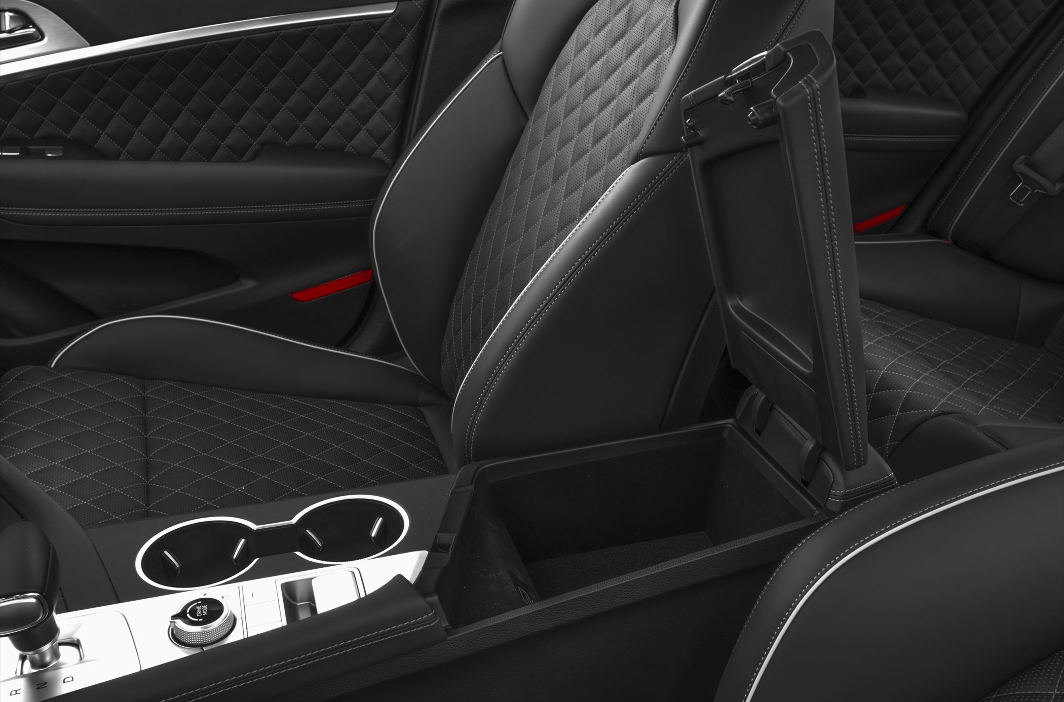 Quilted leather seats with white stitching and open center console storage