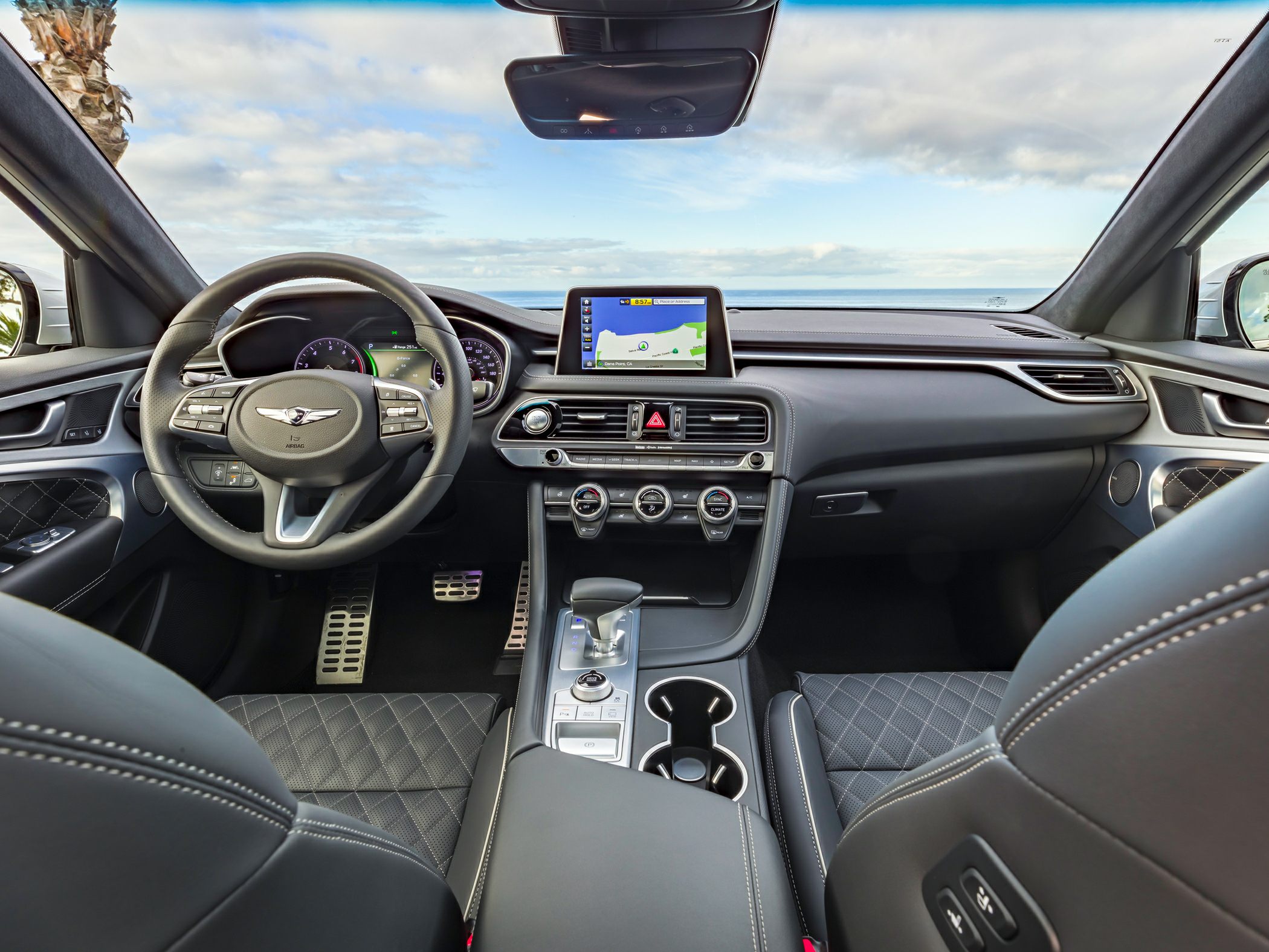 Digital instrument cluster and quilted leather seats in car interior