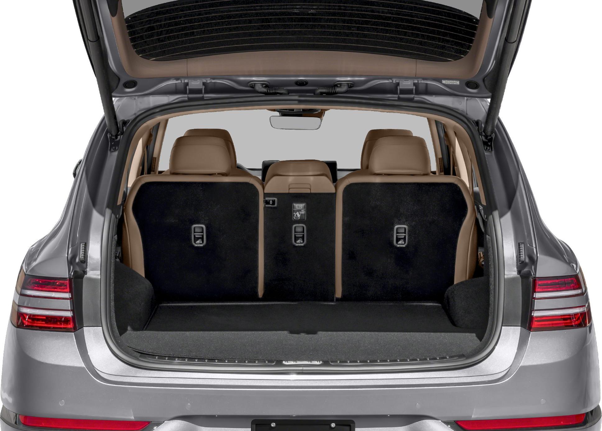 Rear cargo area with foldable seats and open hatch.