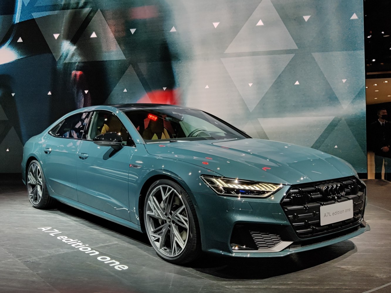 Front-side view of a luxury sedan featuring LED headlights and sporty alloy wheels.