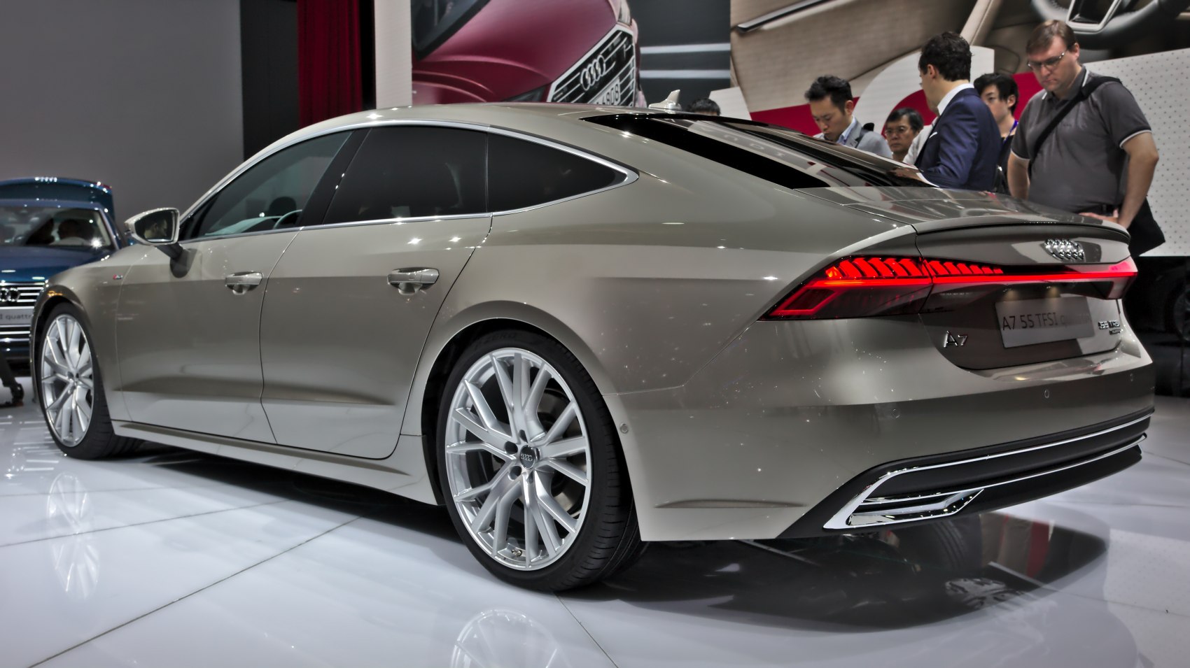 Rear-side view of a luxury sedan with LED tail lights and multi-spoke alloy wheels