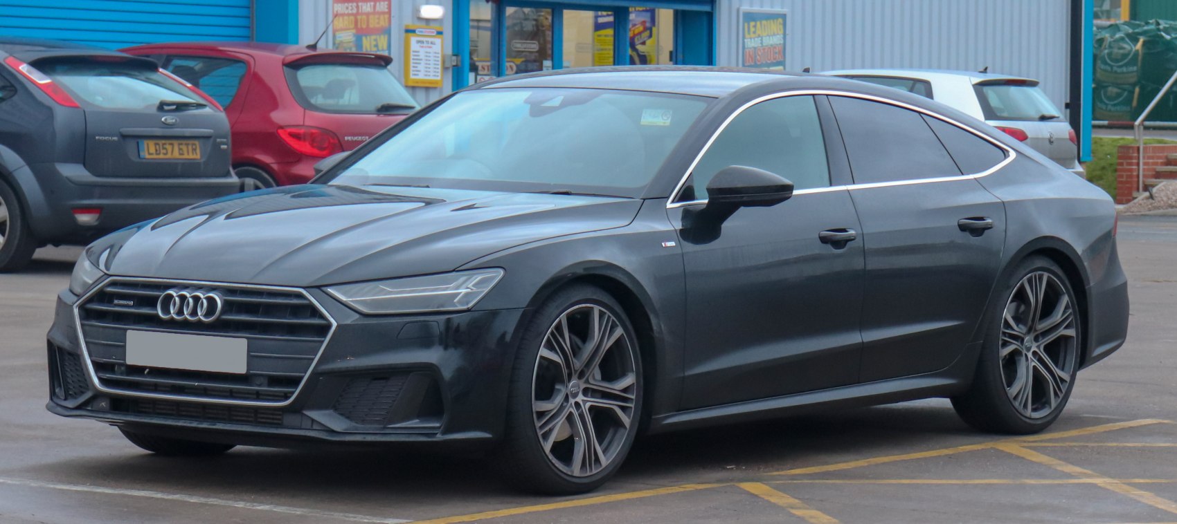 Front three-quarter view with aggressive grille and multi-spoke alloy wheels