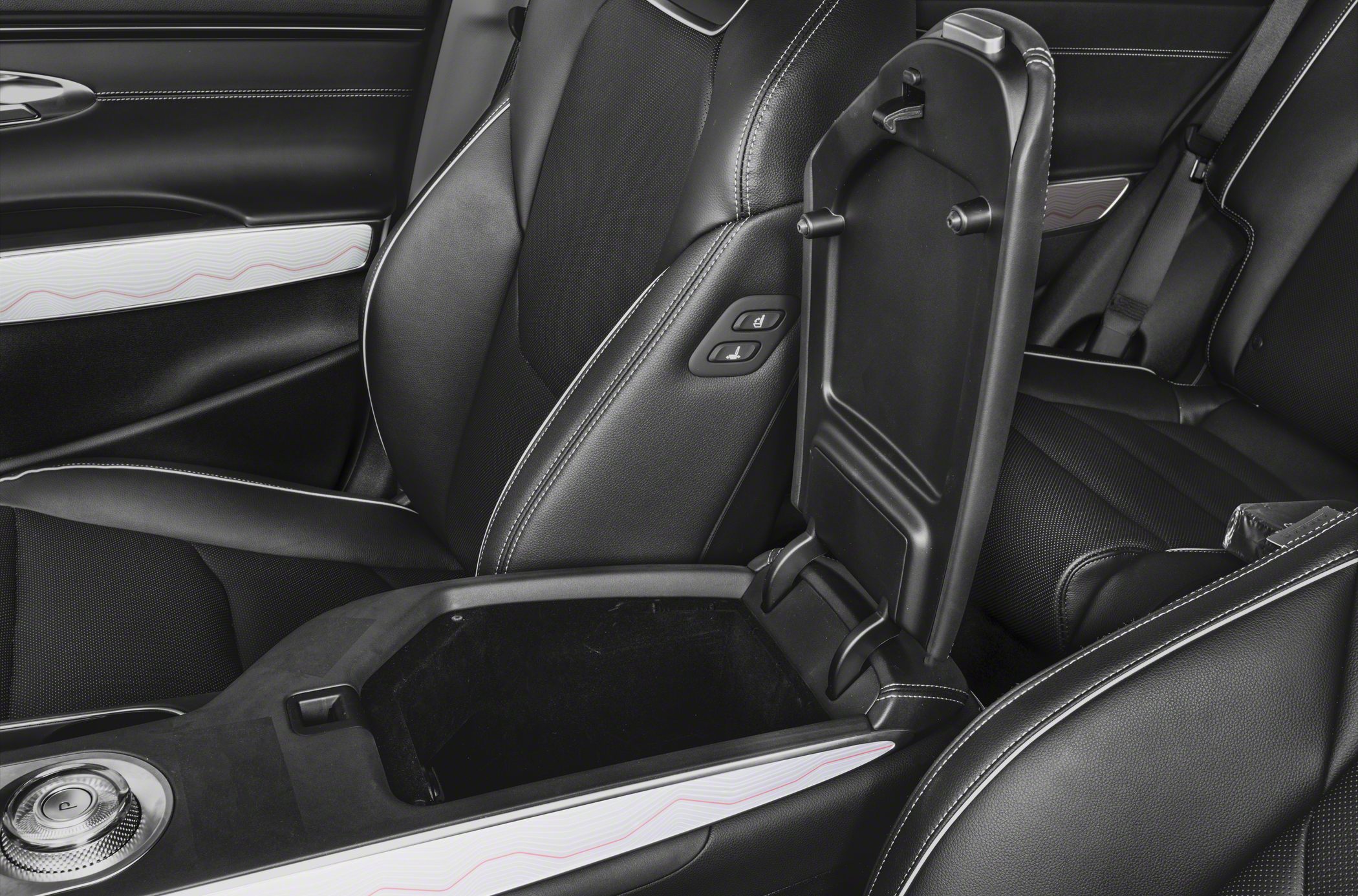 Center console with open armrest storage and black leather seats