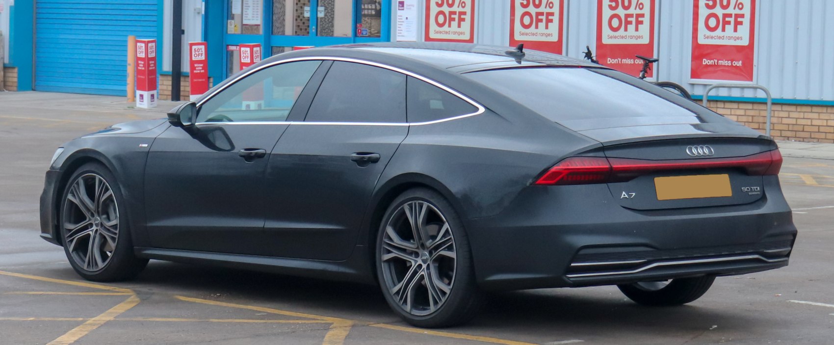 Rear side view with sharp taillights and alloy wheels