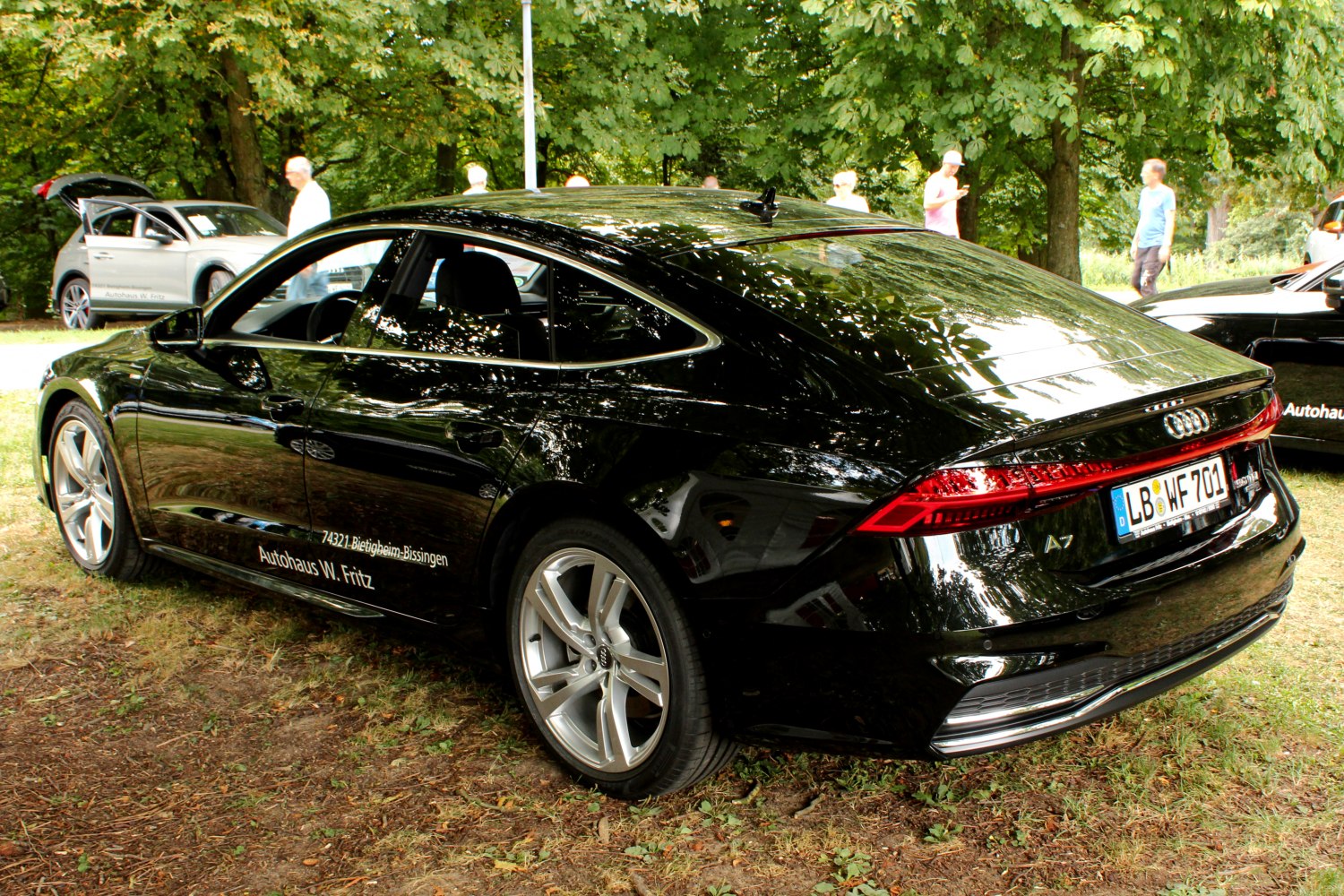 Black four-door sports sedan with LED tail lights and coupe-style roof