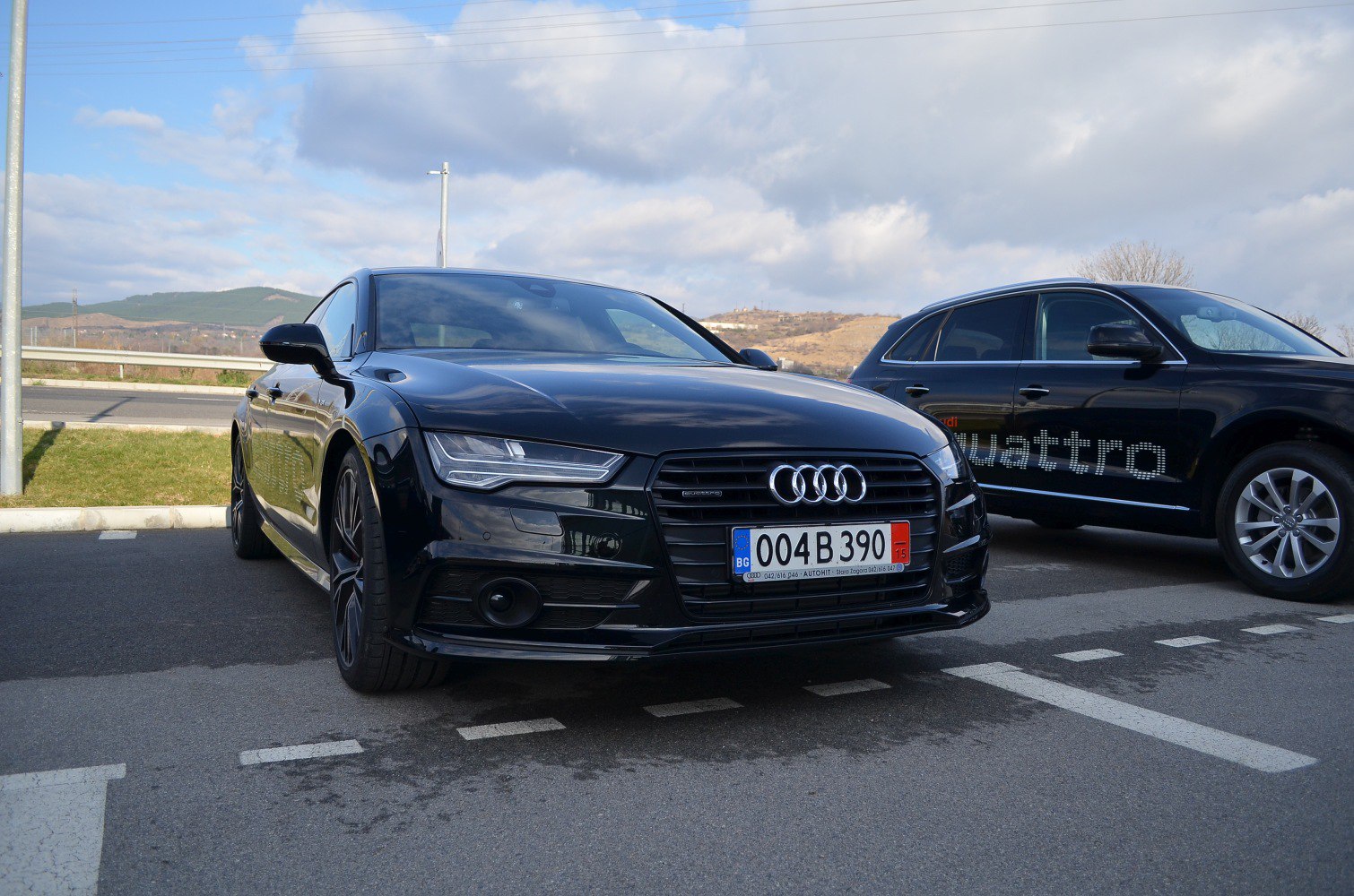 Front view of black luxury sedan with LED headlights and sportback design