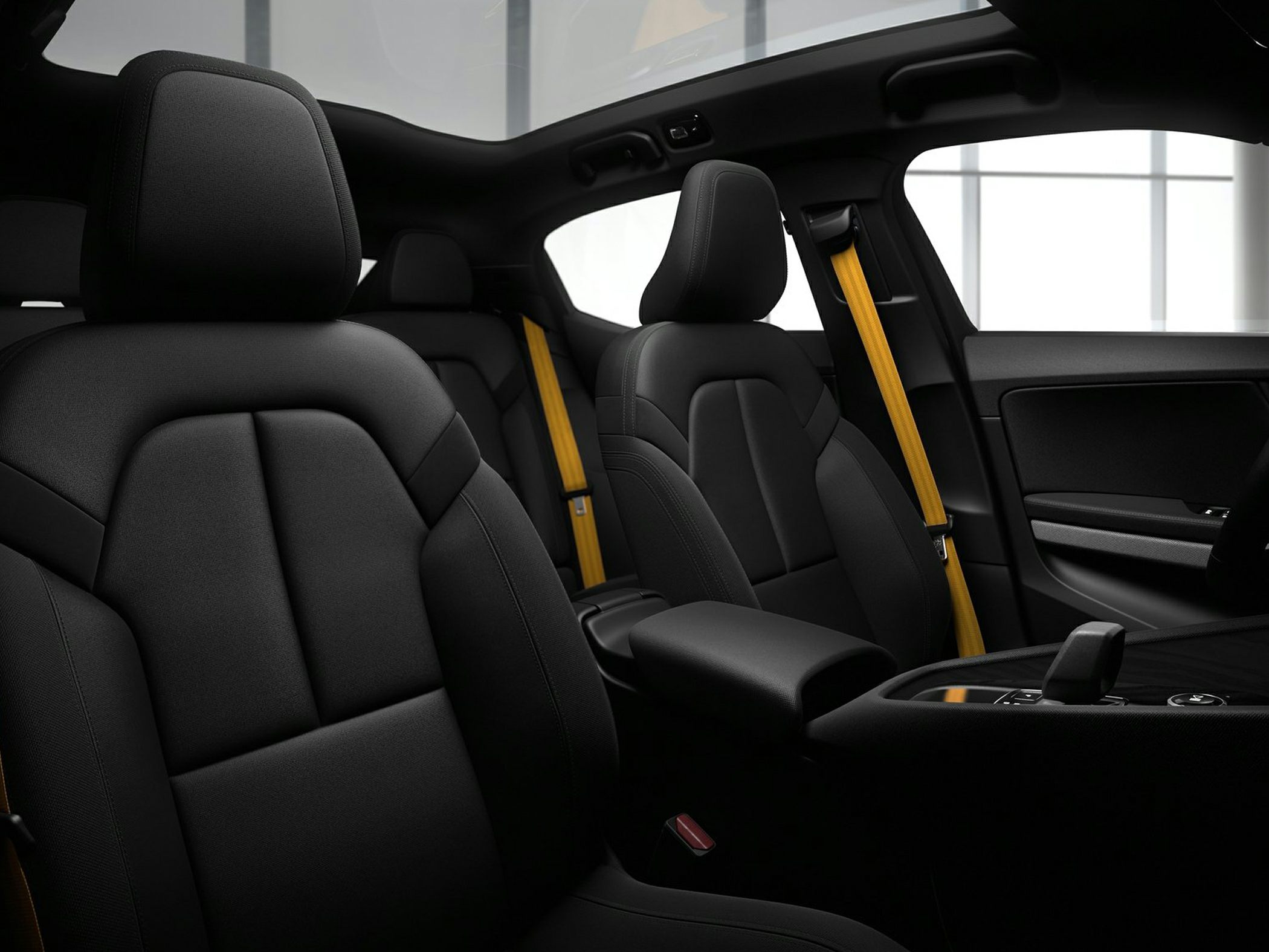 Black car seats with yellow seatbelts and panoramic roof