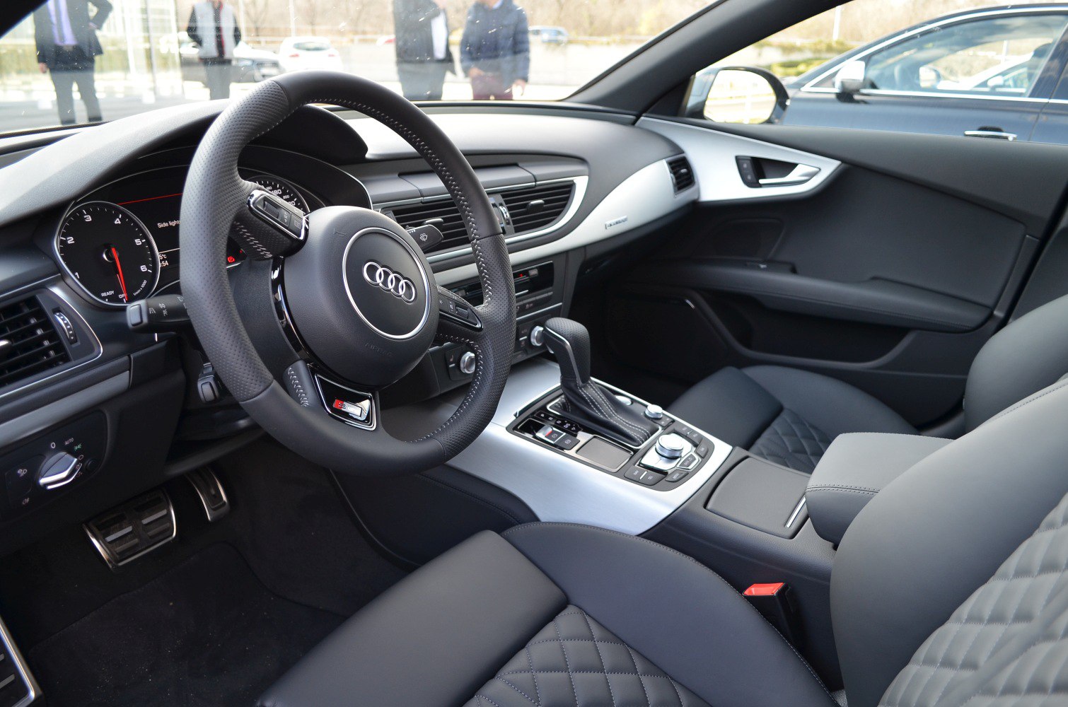 luxury interior with steering wheel, gear shift, quilted leather seats