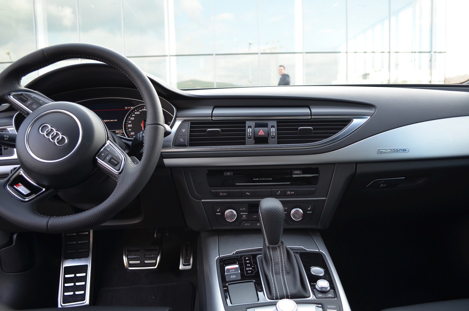 Dashboard, steering wheel, and gear shifter of a luxury sportback interior