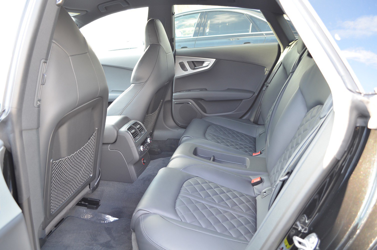 Rear passenger interior with quilted leather seats and climate controls