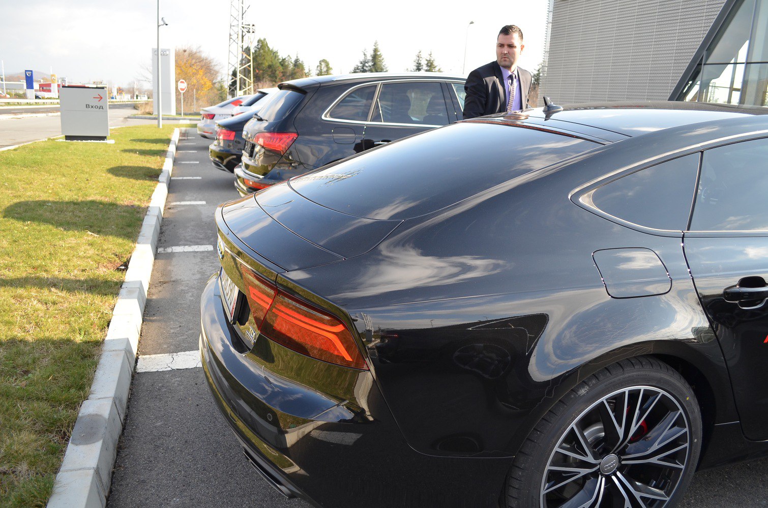Rear and side profile of a black luxury sportback with distinctive tail lights