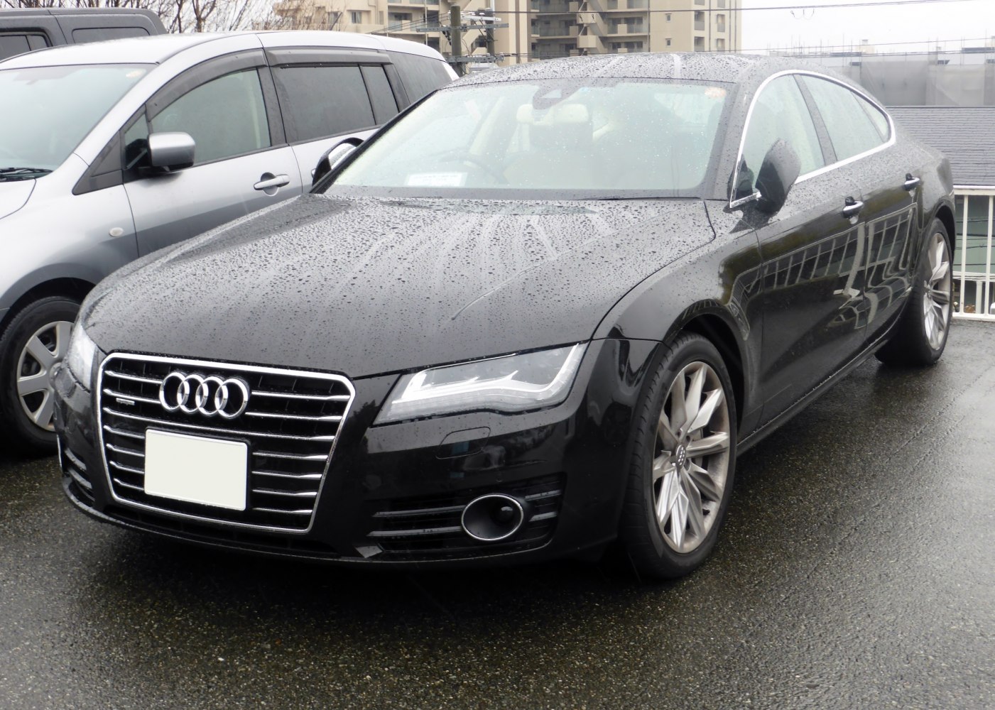 Front grille, headlights, and side profile of a sleek black sedan