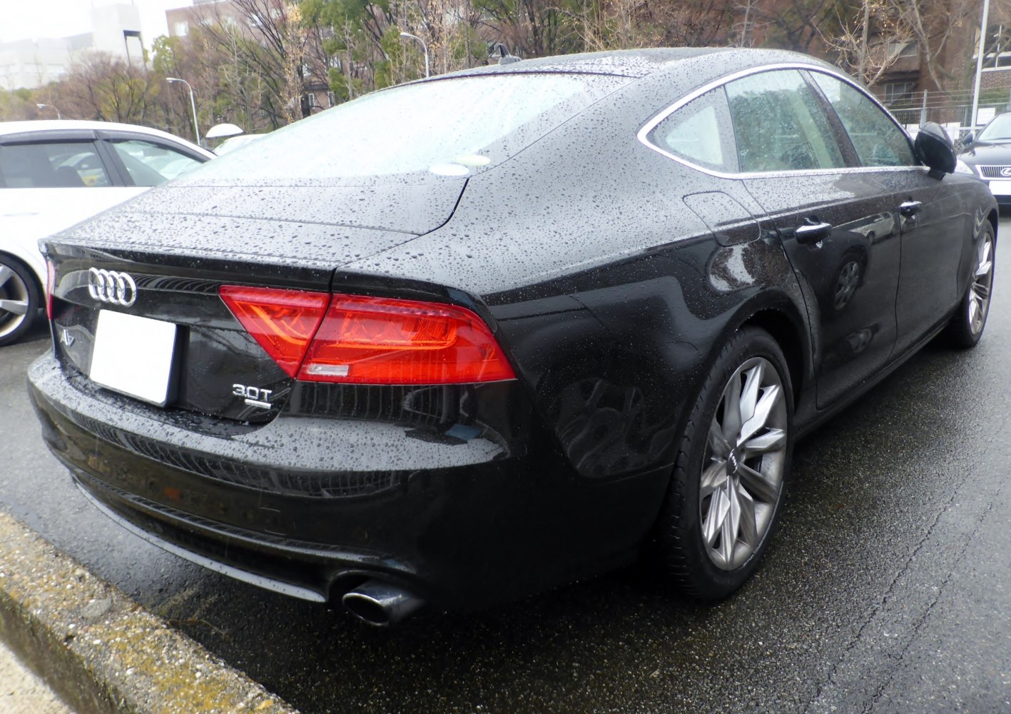 Rear and side view of a luxury sportback with raindrops