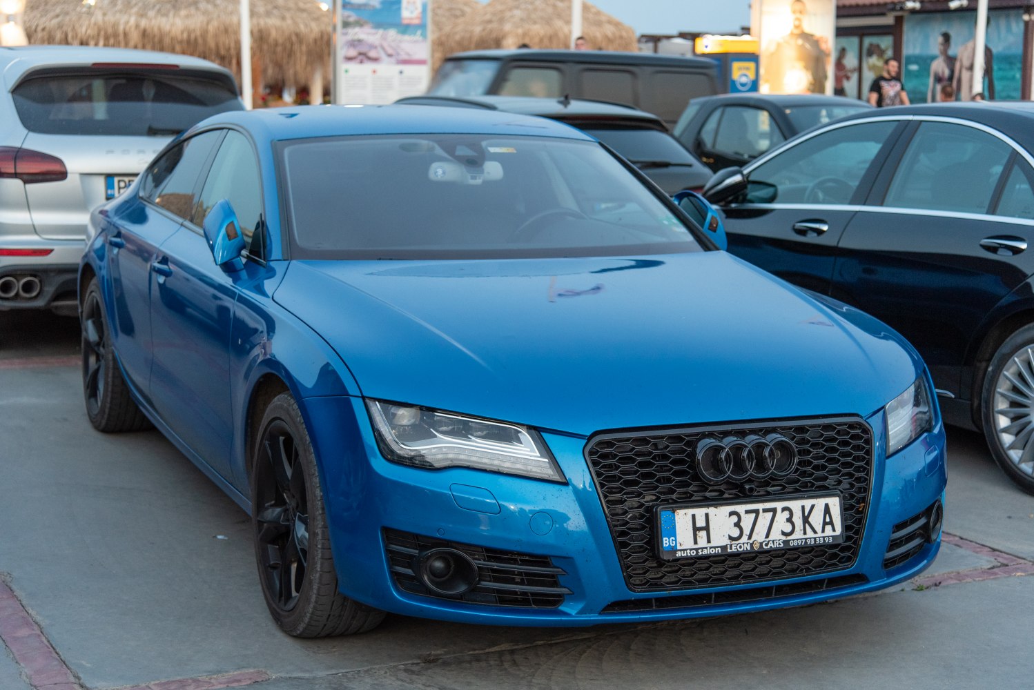 Blue sedan with black honeycomb grille and modern LED headlights