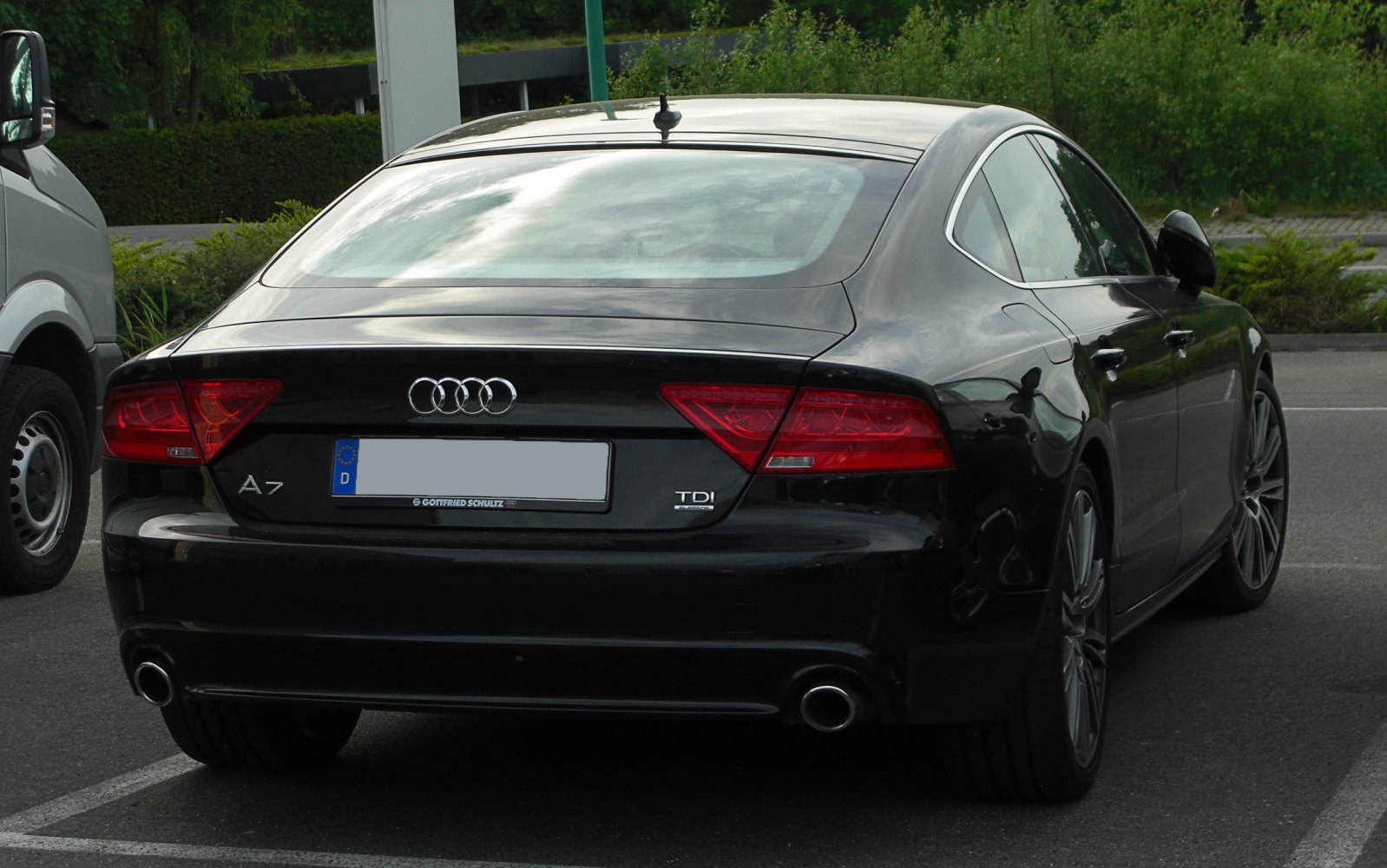 Rear view of luxury coupe with dual exhaust and LED taillights