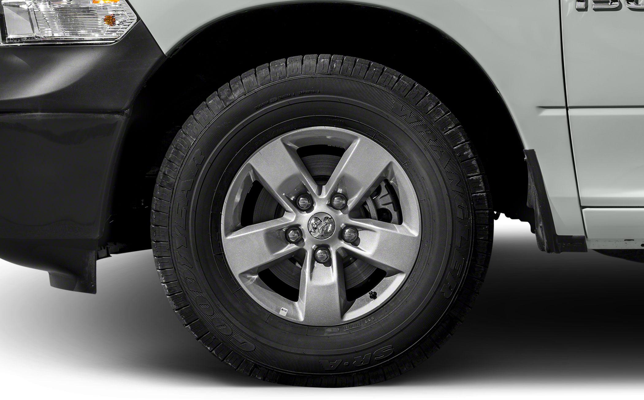 Goodyear Wrangler tire and alloy wheel with 5-spoke design, mudflap visible.