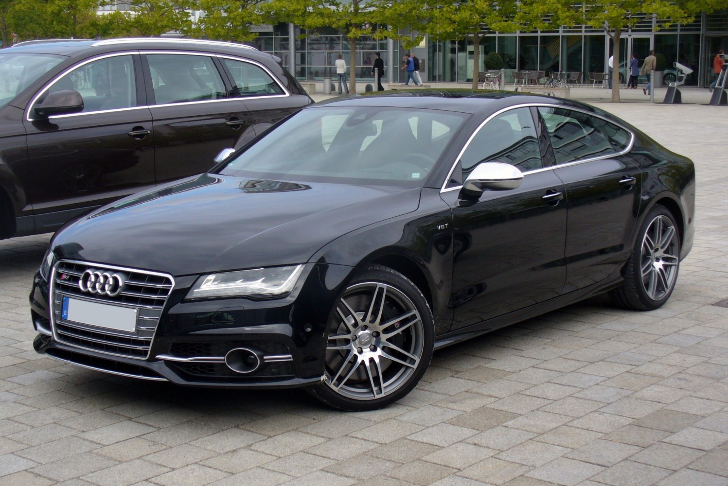 Sleek black sports sedan with V8T badge and distinctive rims