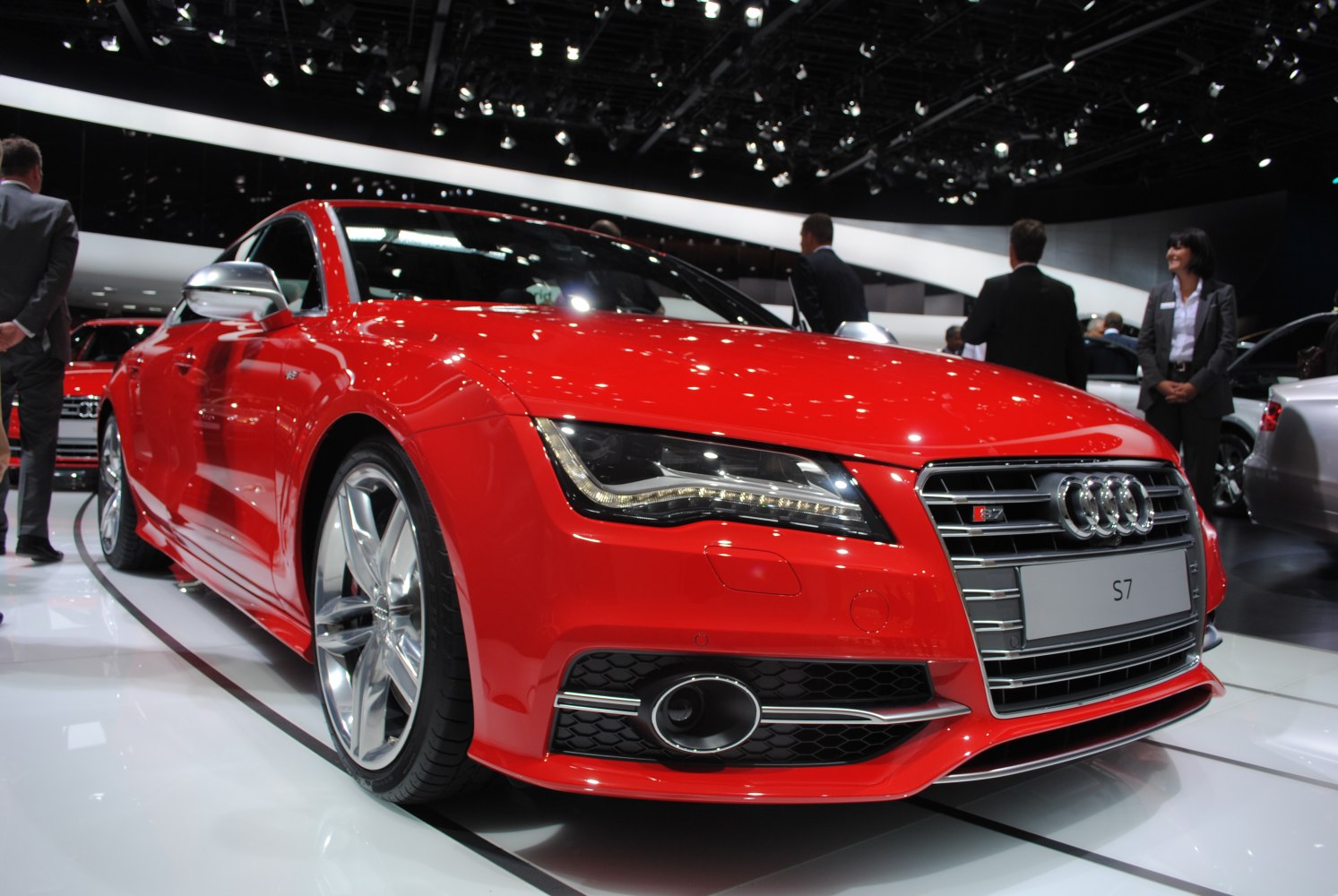 Front close-up of red sporty coupe with LED headlights and chrome grille