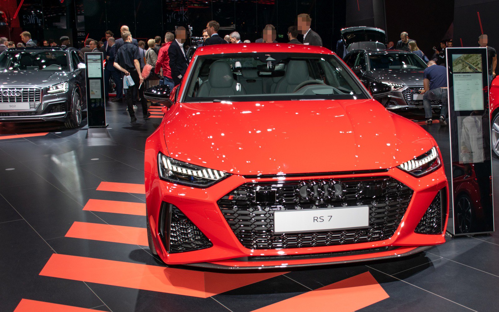 Red car front with aggressive grille and LED headlights
