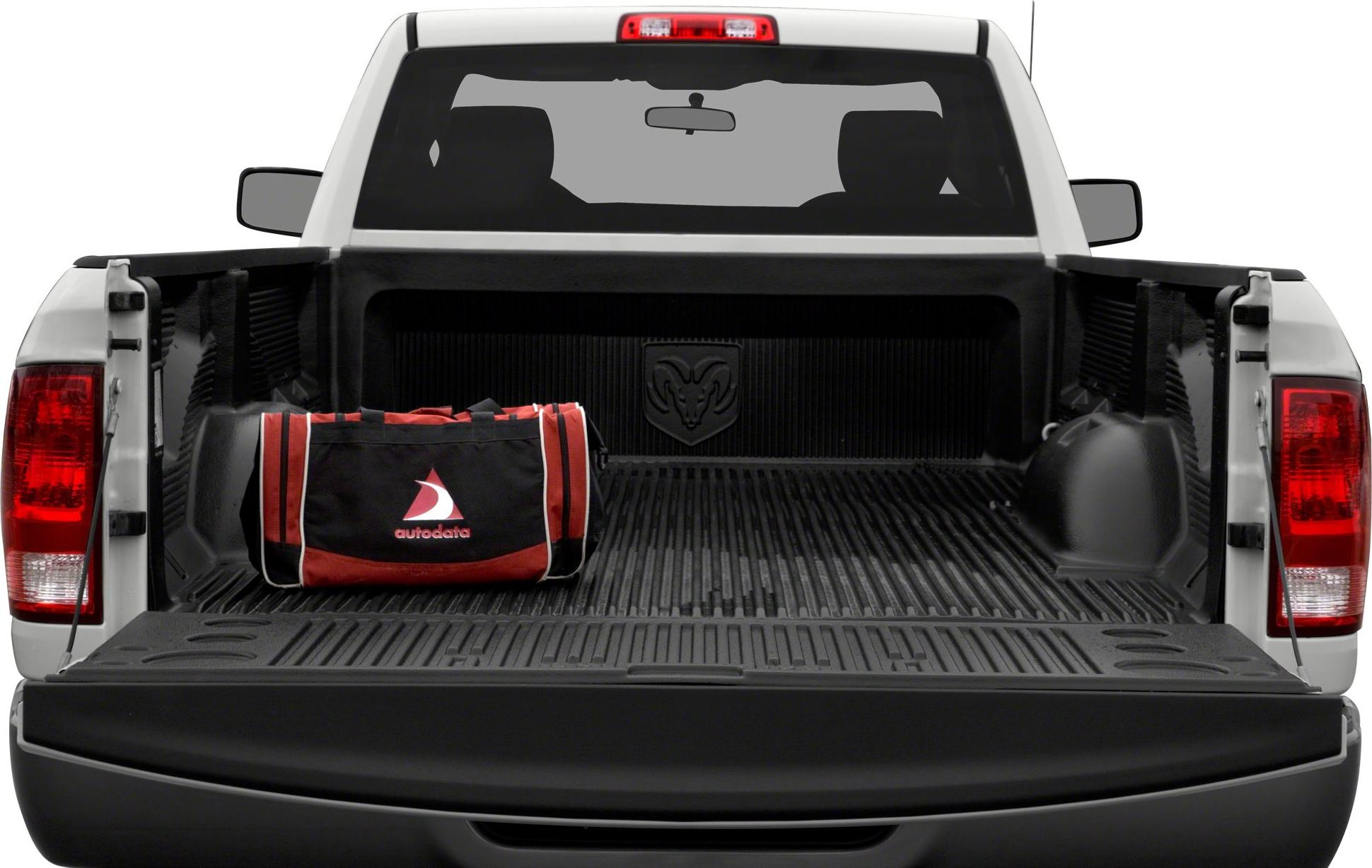 Open pickup truck bed with black liner and duffle bag