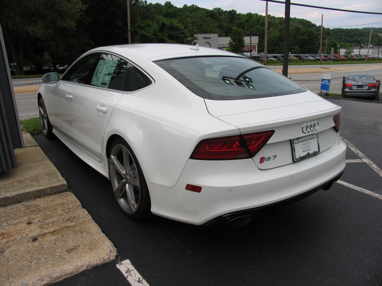 Rear side view with sharp taillights and large alloy wheels